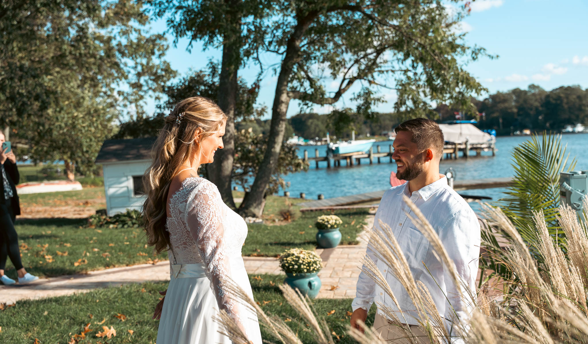 First look on the lawn above the creek — backyard wedding in Annapolis, Maryland