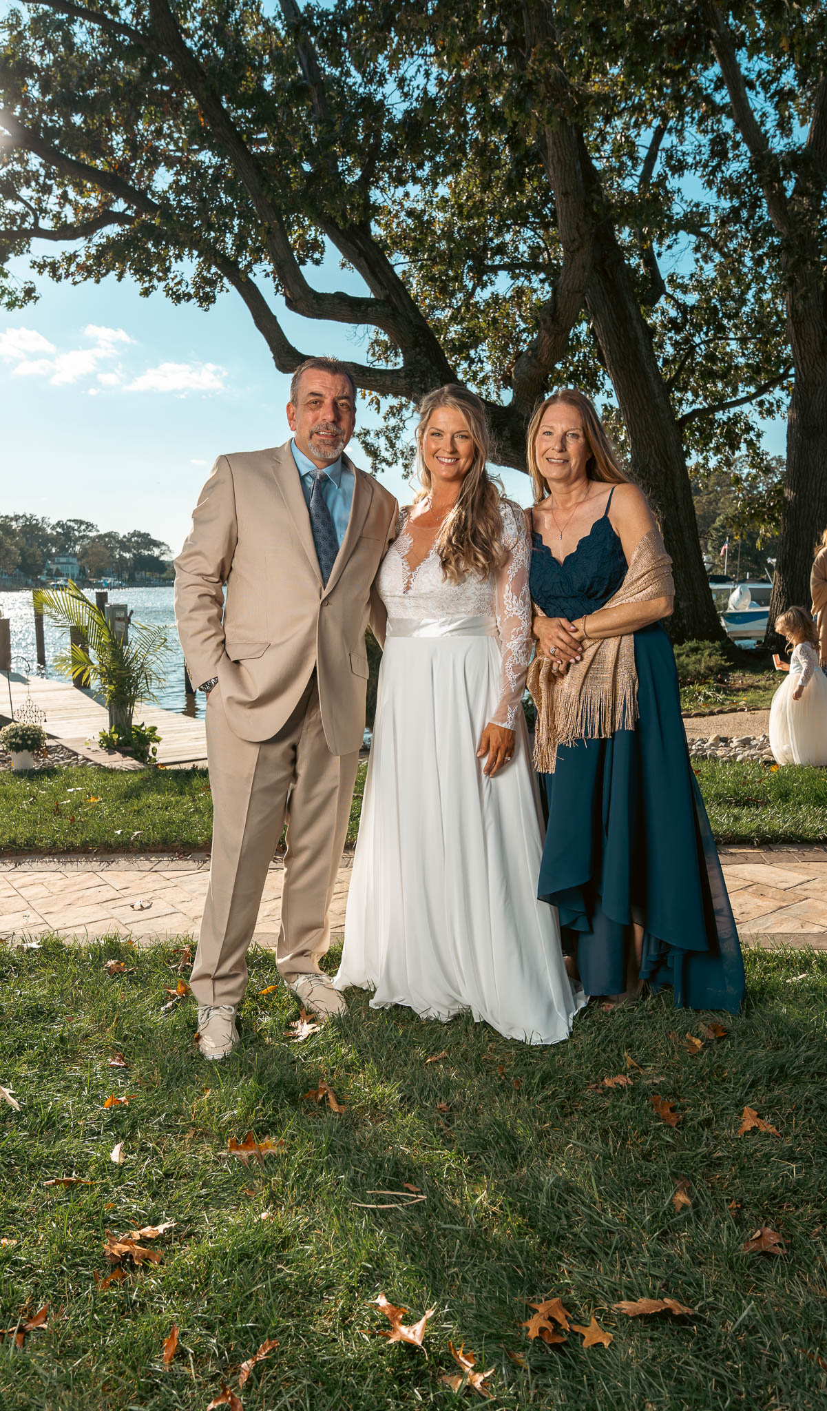 Family group beneath the oak on the lawn — backyard wedding in Annapolis, Maryland