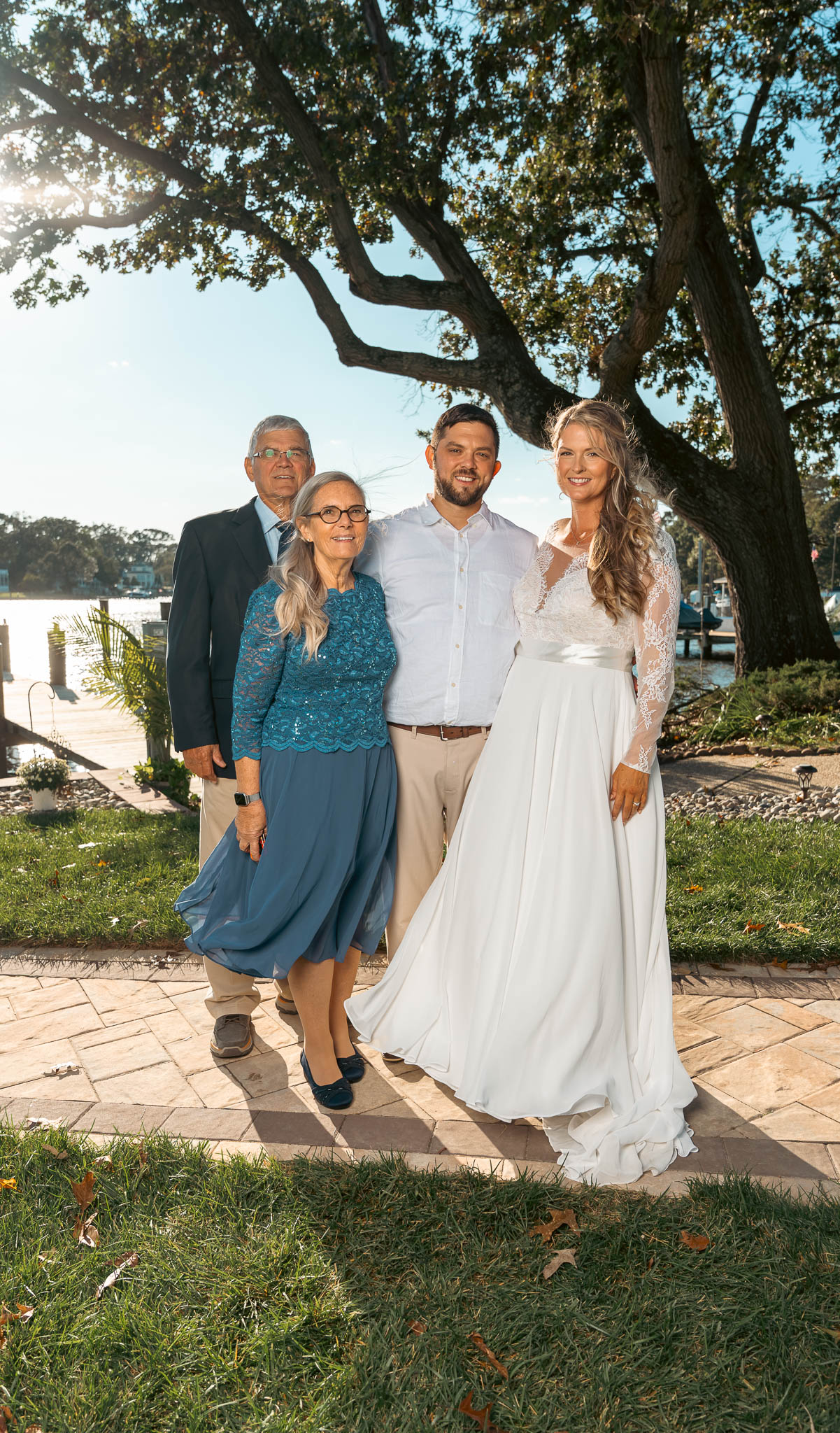 Group portrait with the creek behind — backyard wedding in Annapolis, Maryland