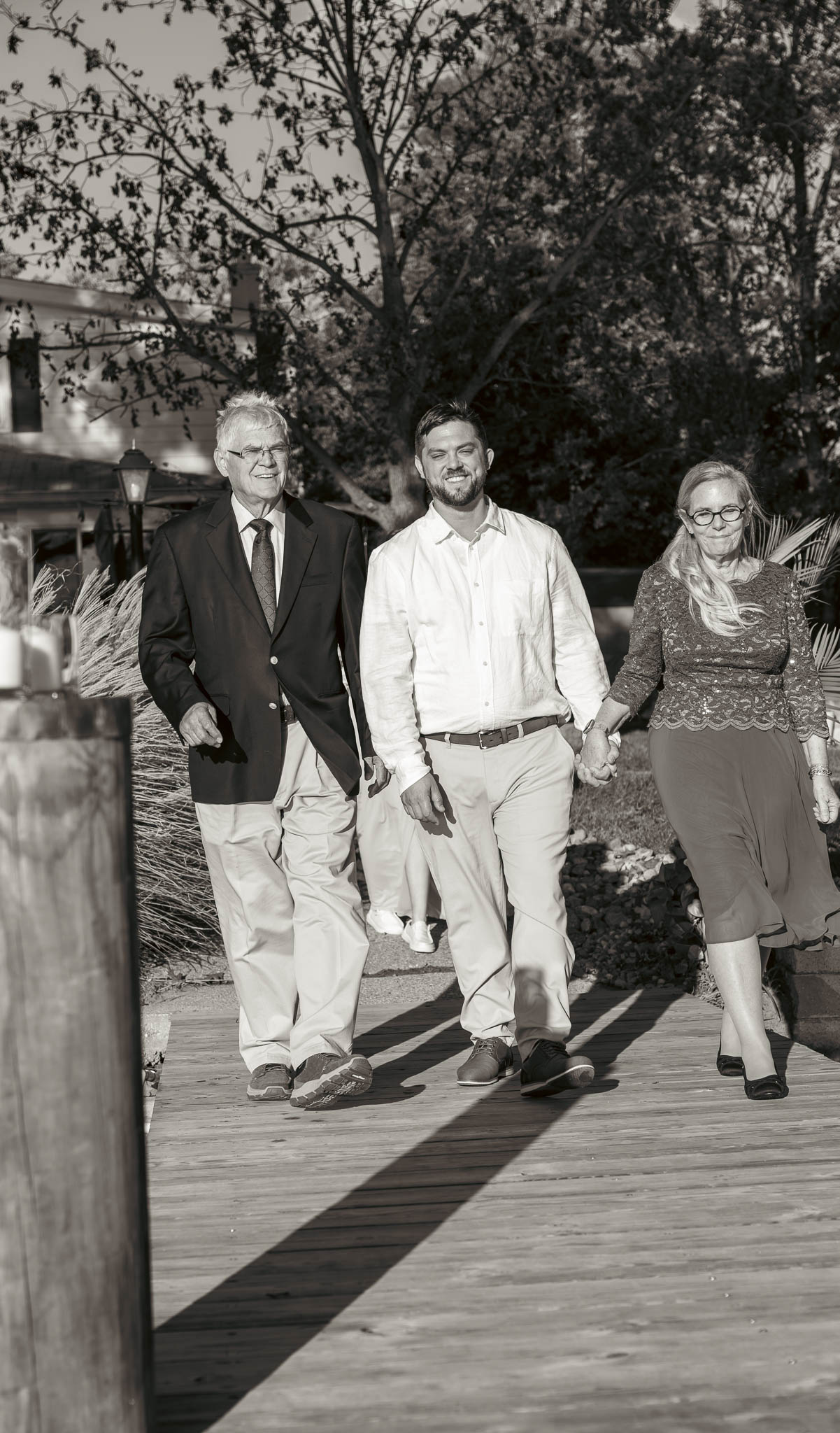 Family making their way to the ceremony on the dock — backyard wedding in Annapolis, Maryland