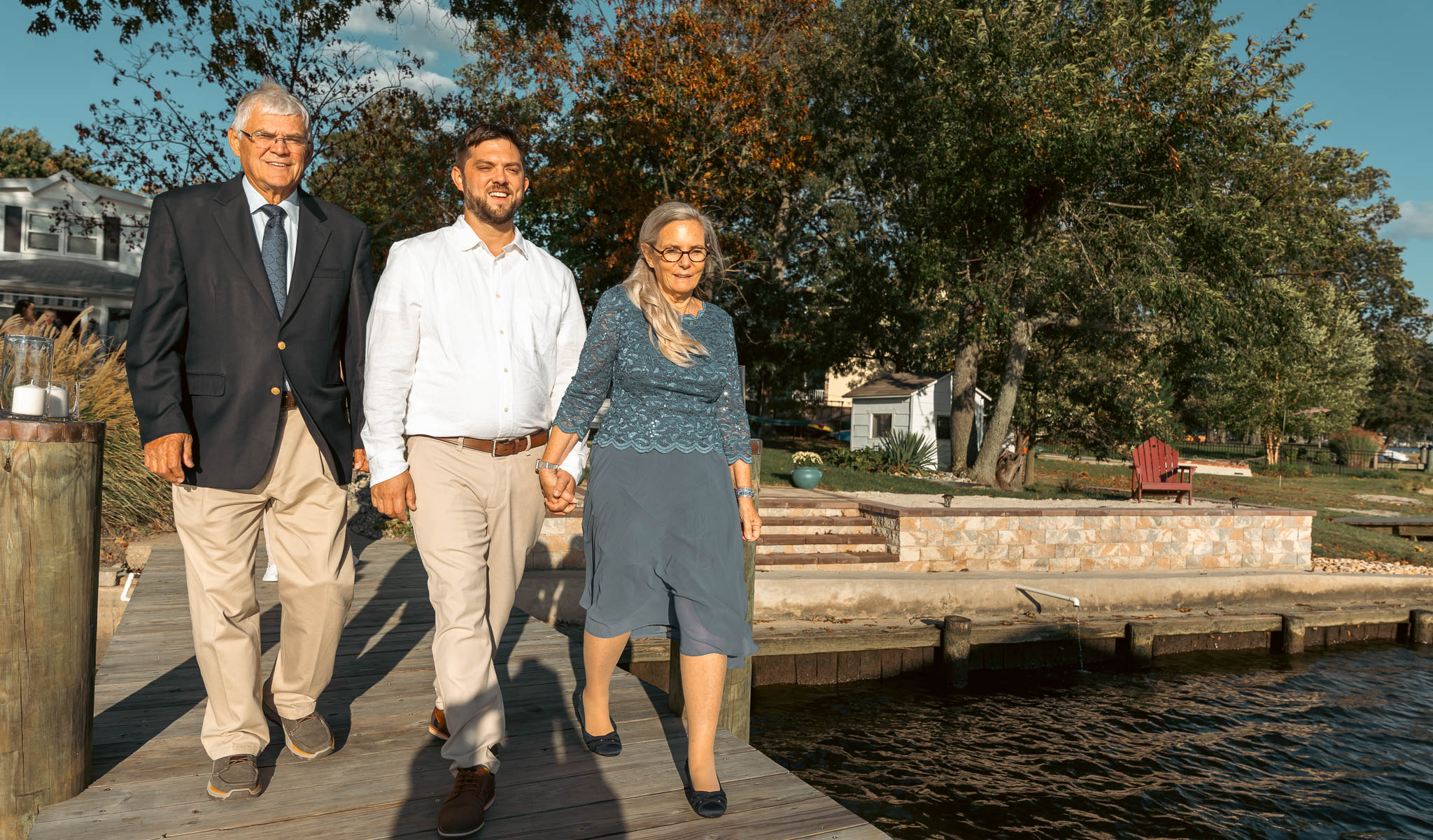 Guests walking down the dock before the ceremony — backyard wedding in Annapolis, Maryland