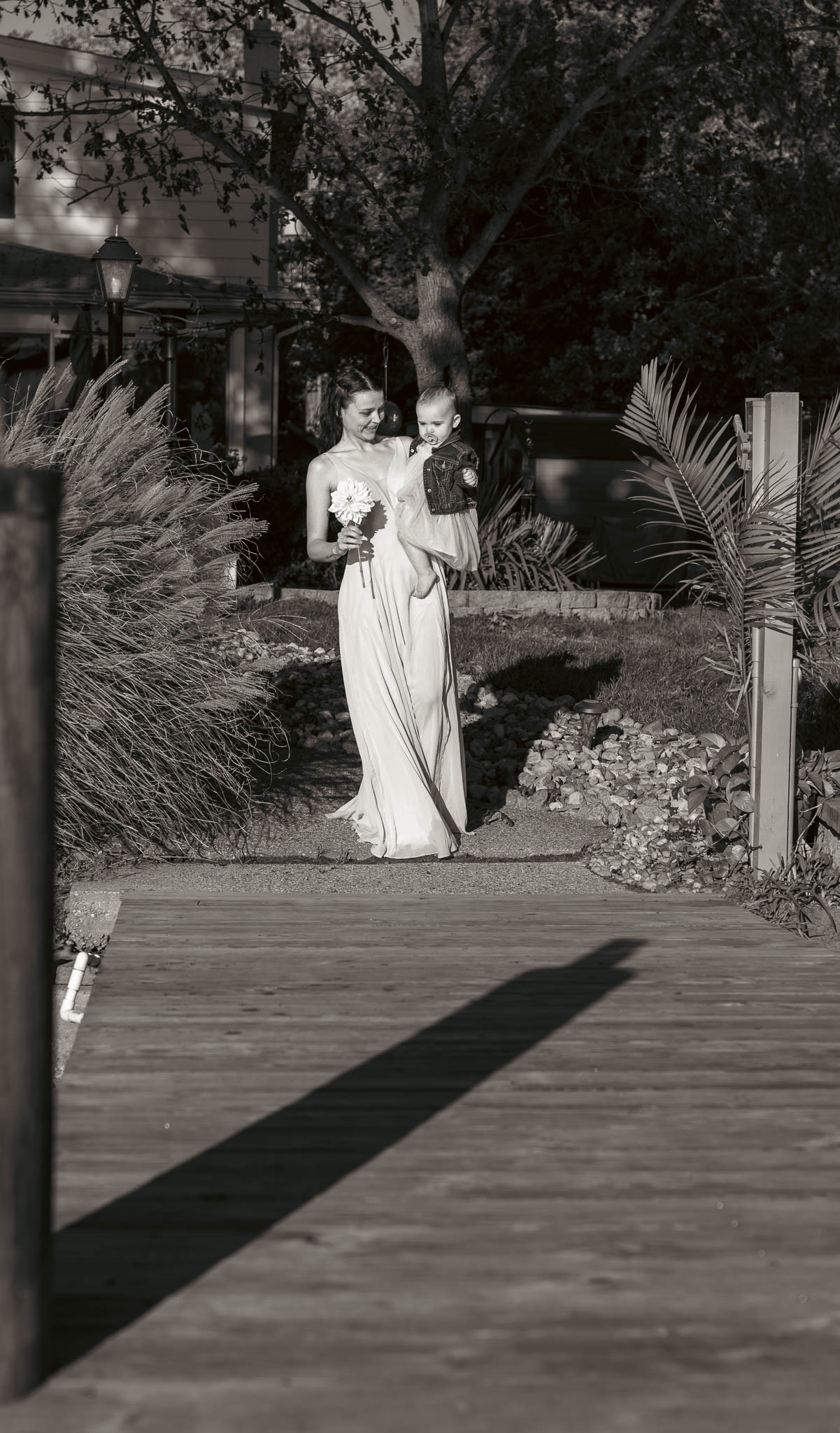 Family making their way to the ceremony on the dock — backyard wedding in Annapolis, Maryland