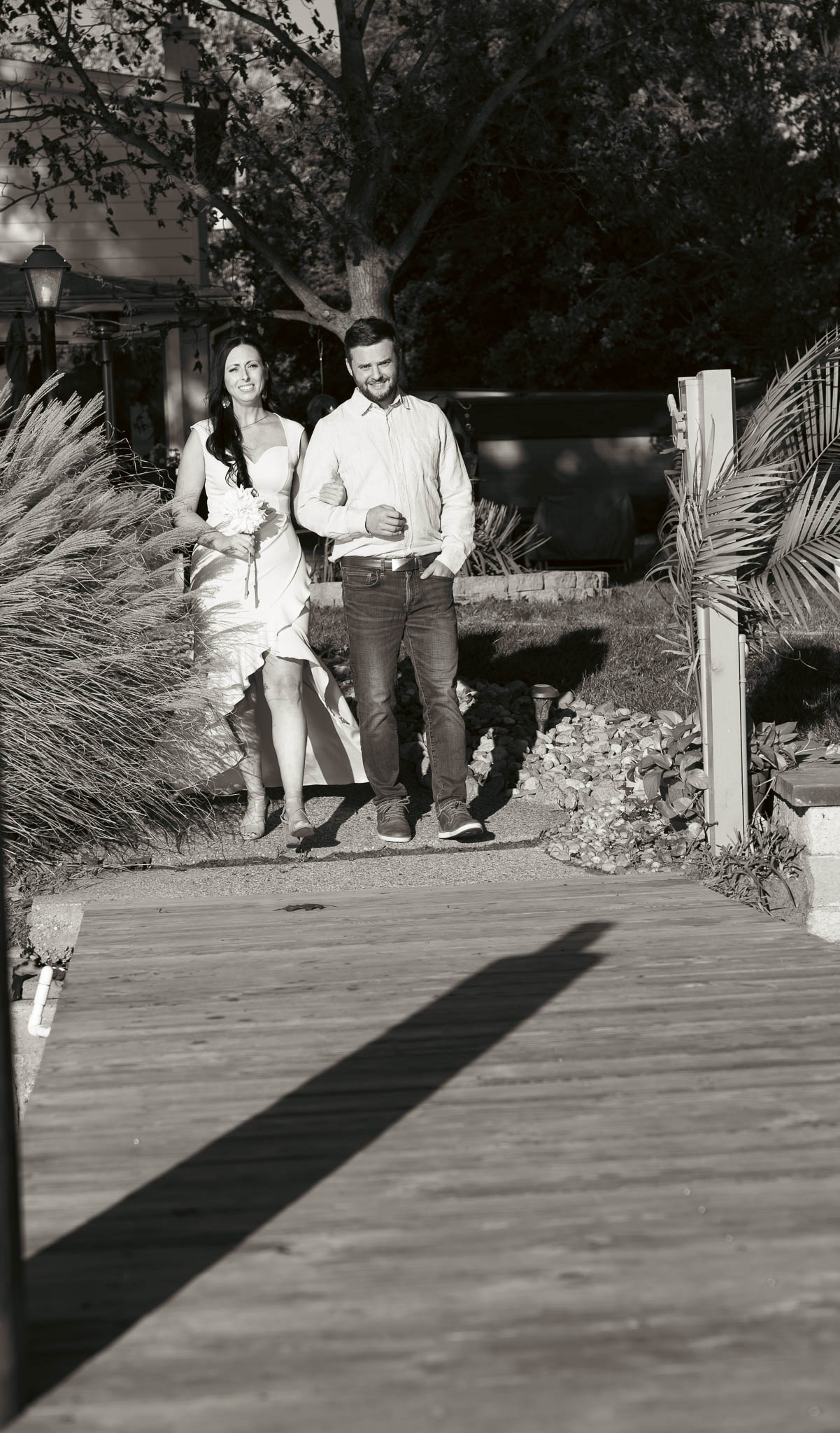 Guests walking down the dock before the ceremony — backyard wedding in Annapolis, Maryland