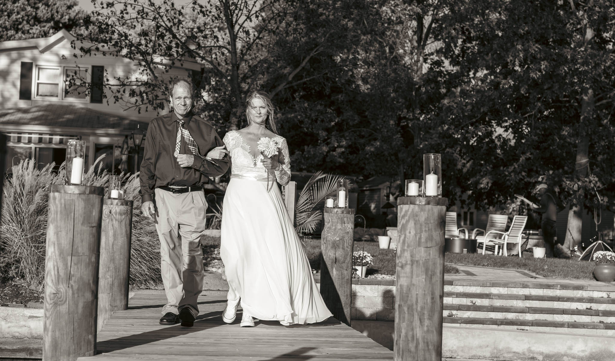 Walking to the ceremony at the end of the dock — backyard wedding in Annapolis, Maryland