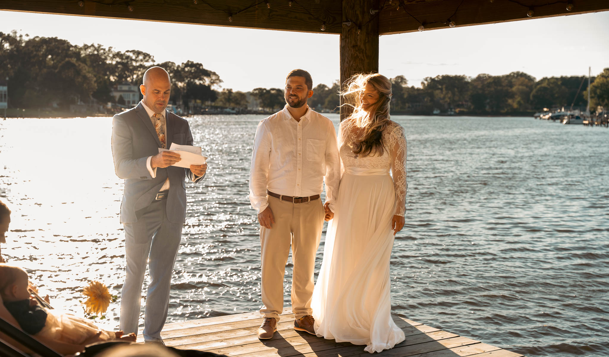 Wedding ceremony under the pavilion at the end of the dock — backyard wedding in Annapolis, Maryland