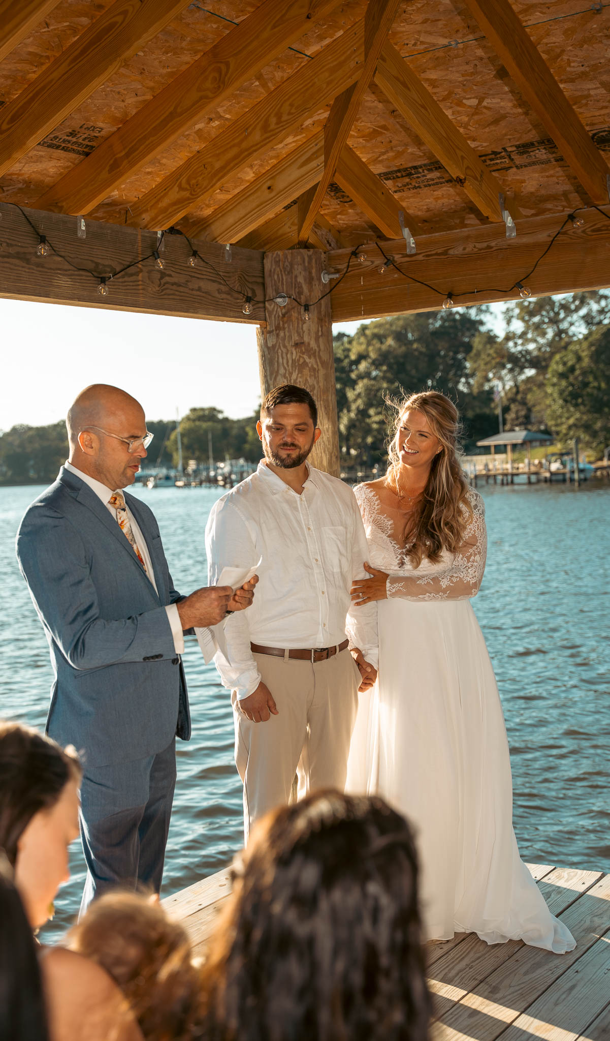 Wedding ceremony under the pavilion at the end of the dock — backyard wedding in Annapolis, Maryland