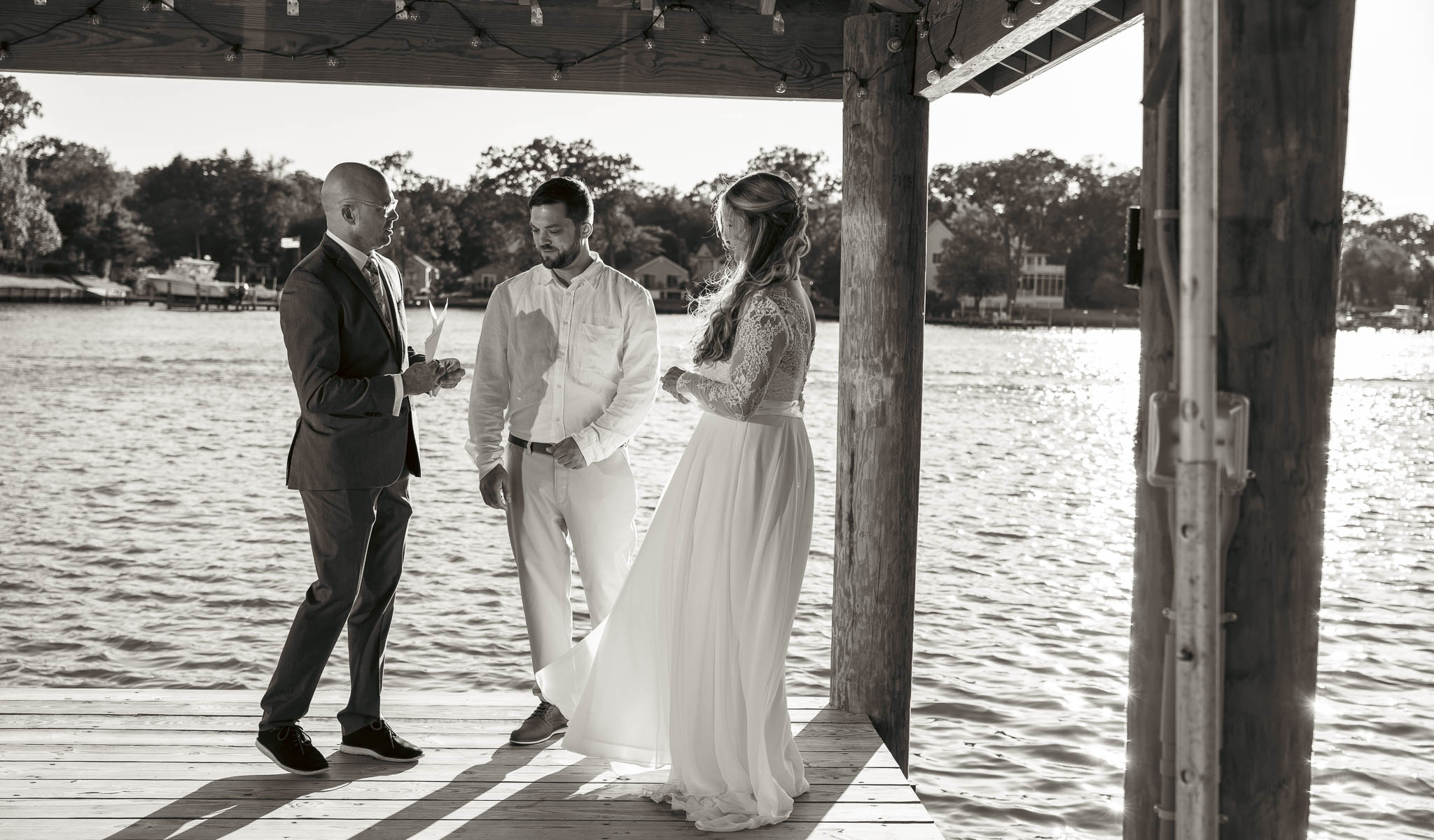 Wedding ceremony under the pavilion at the end of the dock — backyard wedding in Annapolis, Maryland