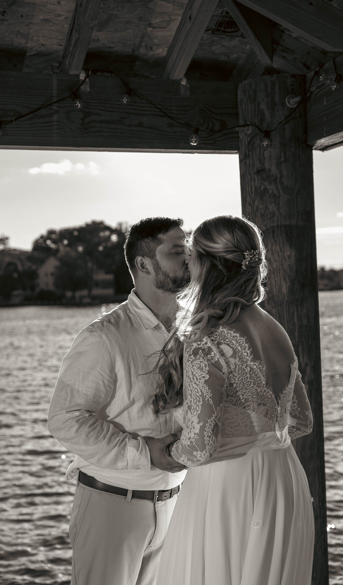 Waterfront ceremony under the boathouse roof — backyard wedding in Annapolis, Maryland