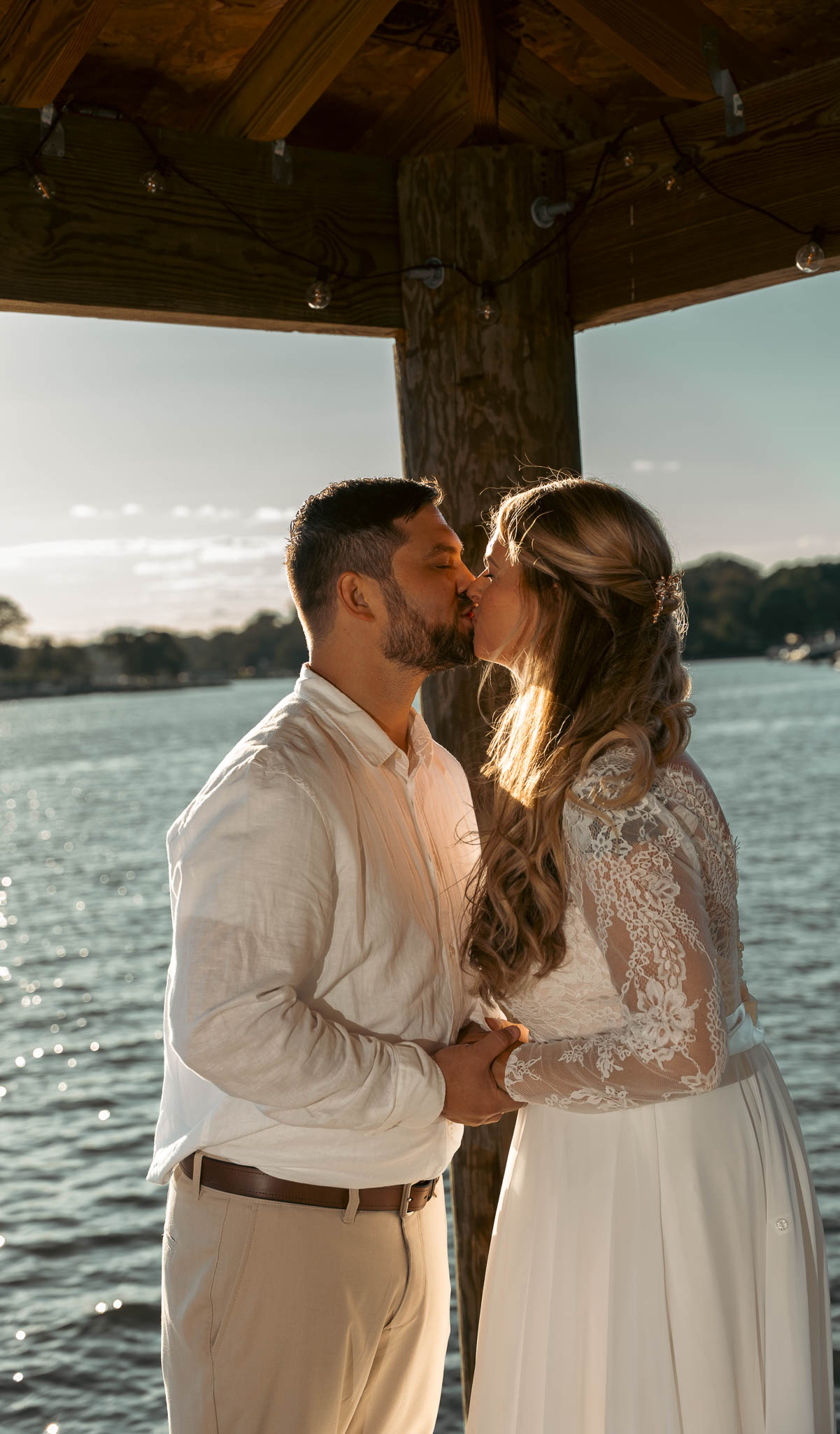 Bride and groom just after the ceremony on the dock — backyard wedding in Annapolis, Maryland