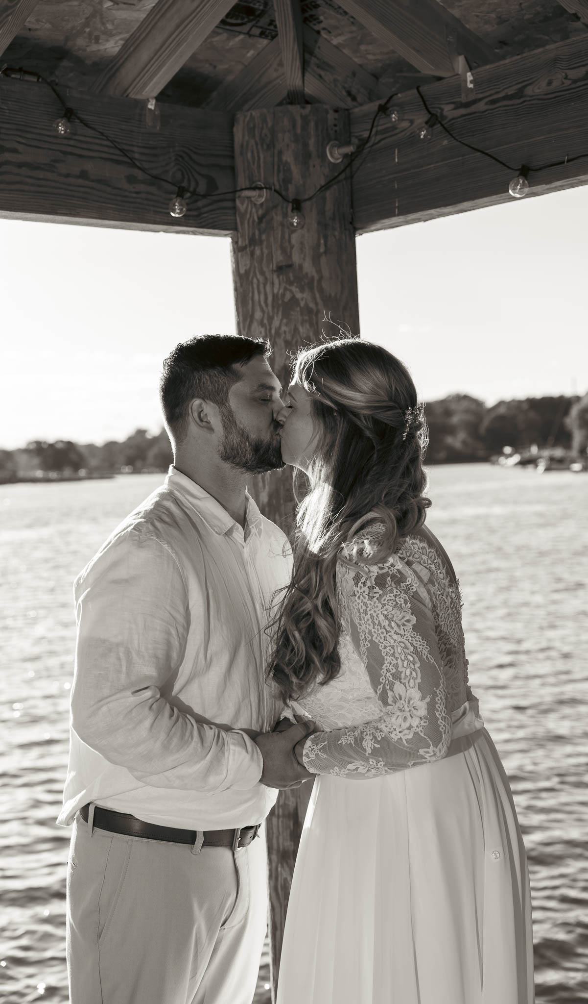 The couple walking back up the dock after their vows — backyard wedding in Annapolis, Maryland