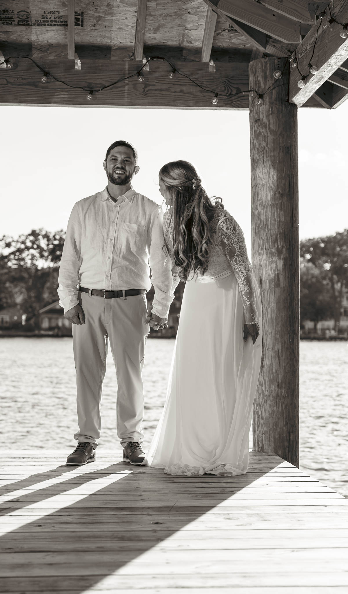 The couple walking back up the dock after their vows — backyard wedding in Annapolis, Maryland