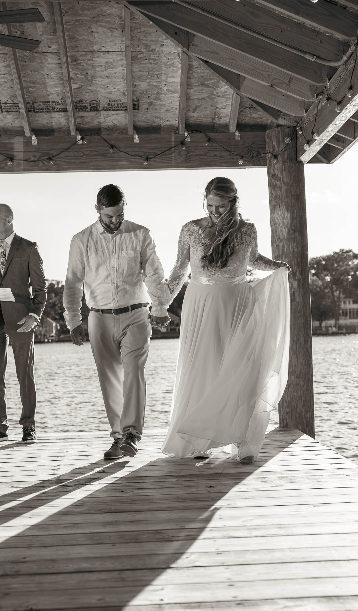 Bride and groom just after the ceremony on the dock — backyard wedding in Annapolis, Maryland