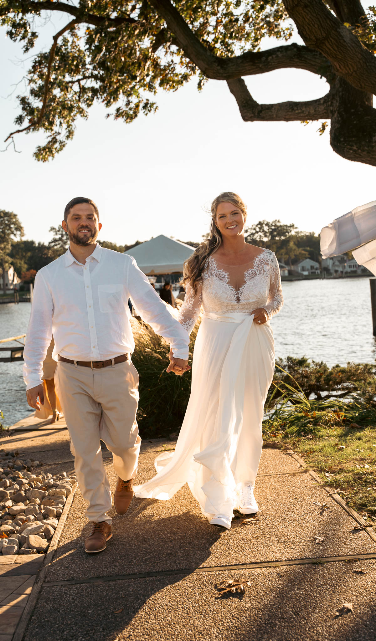 The couple walking back up the dock after their vows — backyard wedding in Annapolis, Maryland