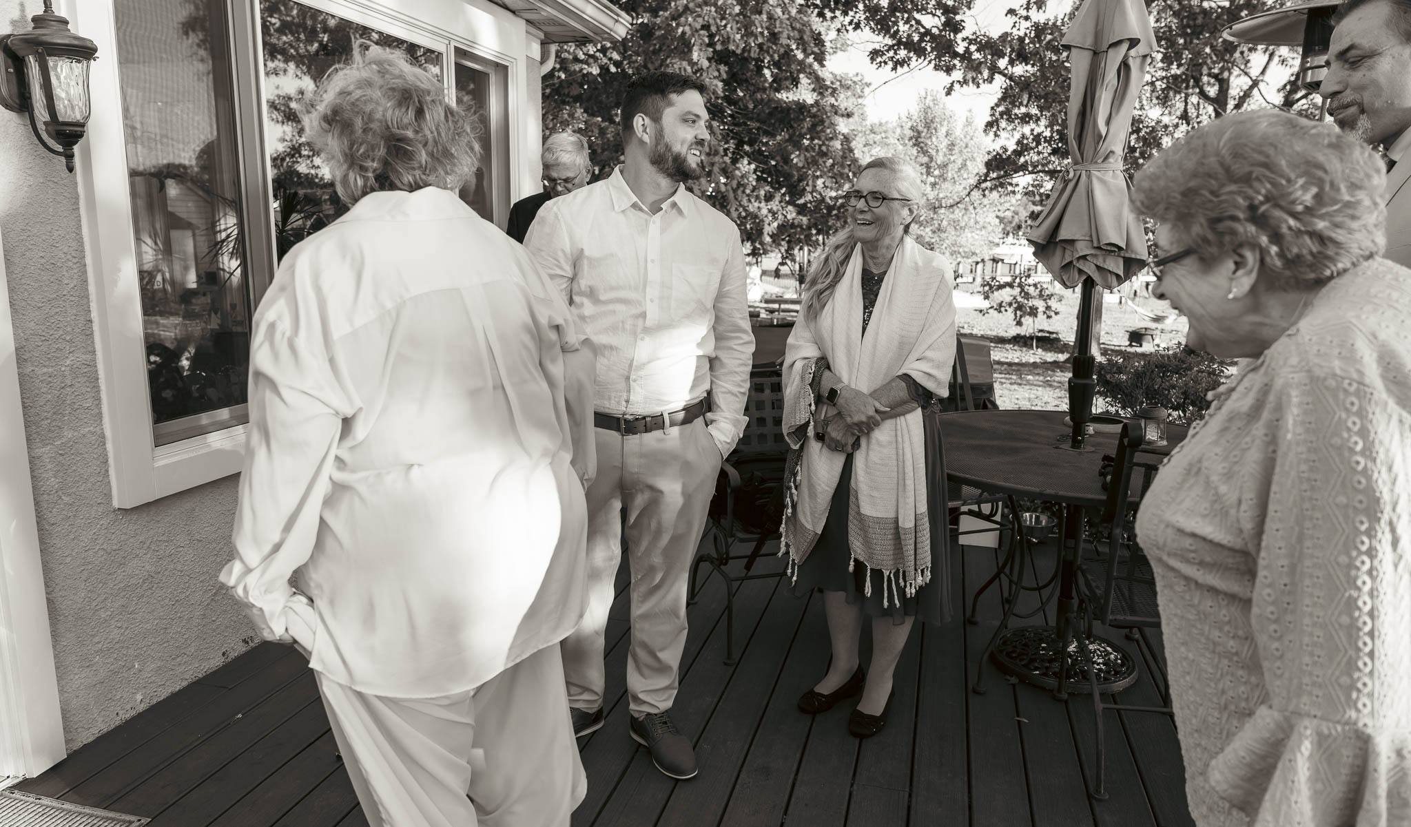 Friends catching up on the waterfront lawn — backyard wedding in Annapolis, Maryland