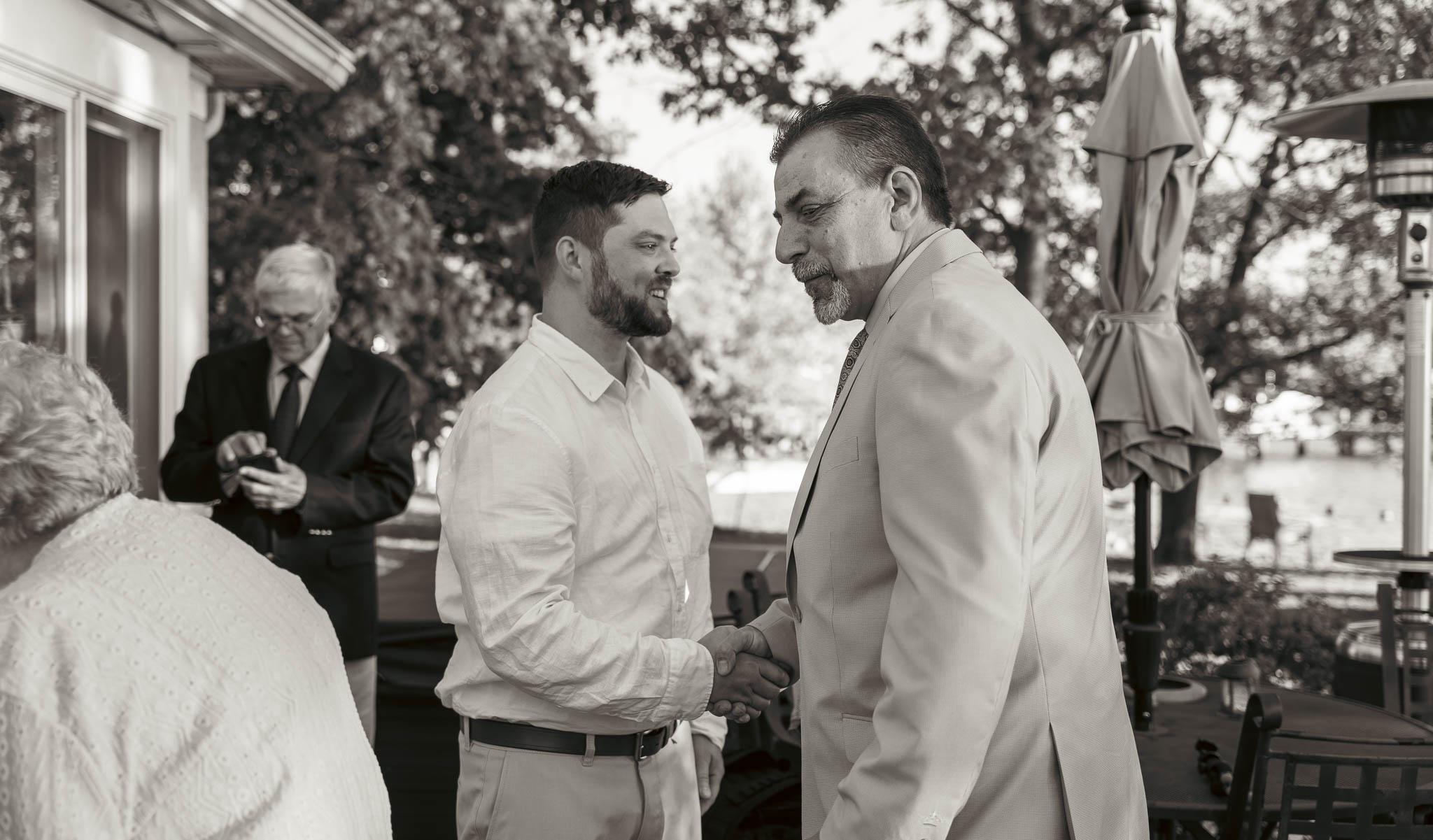 The party spreading out across the yard after the ceremony — backyard wedding in Annapolis, Maryland