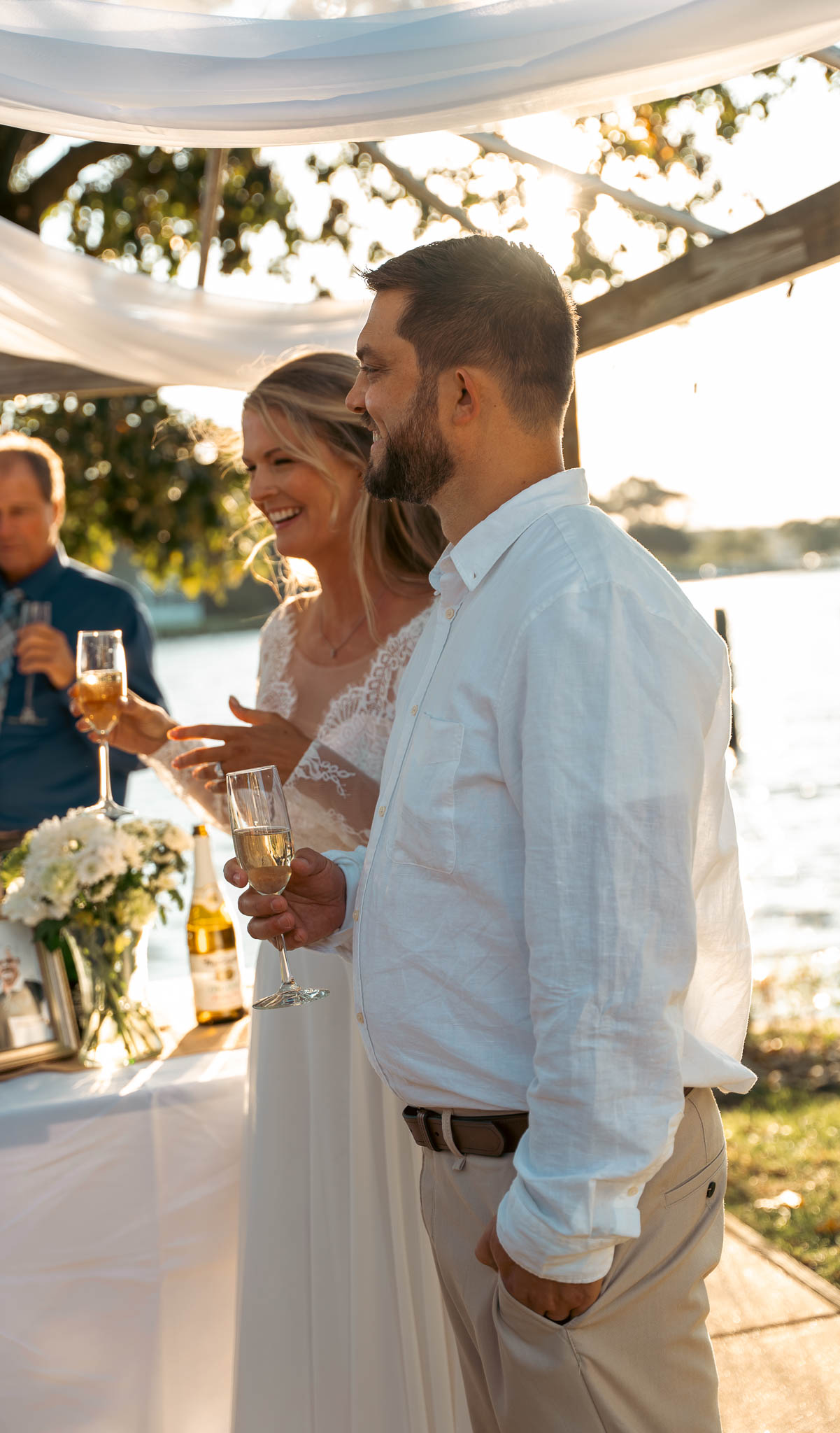 Friends catching up on the waterfront lawn — backyard wedding in Annapolis, Maryland