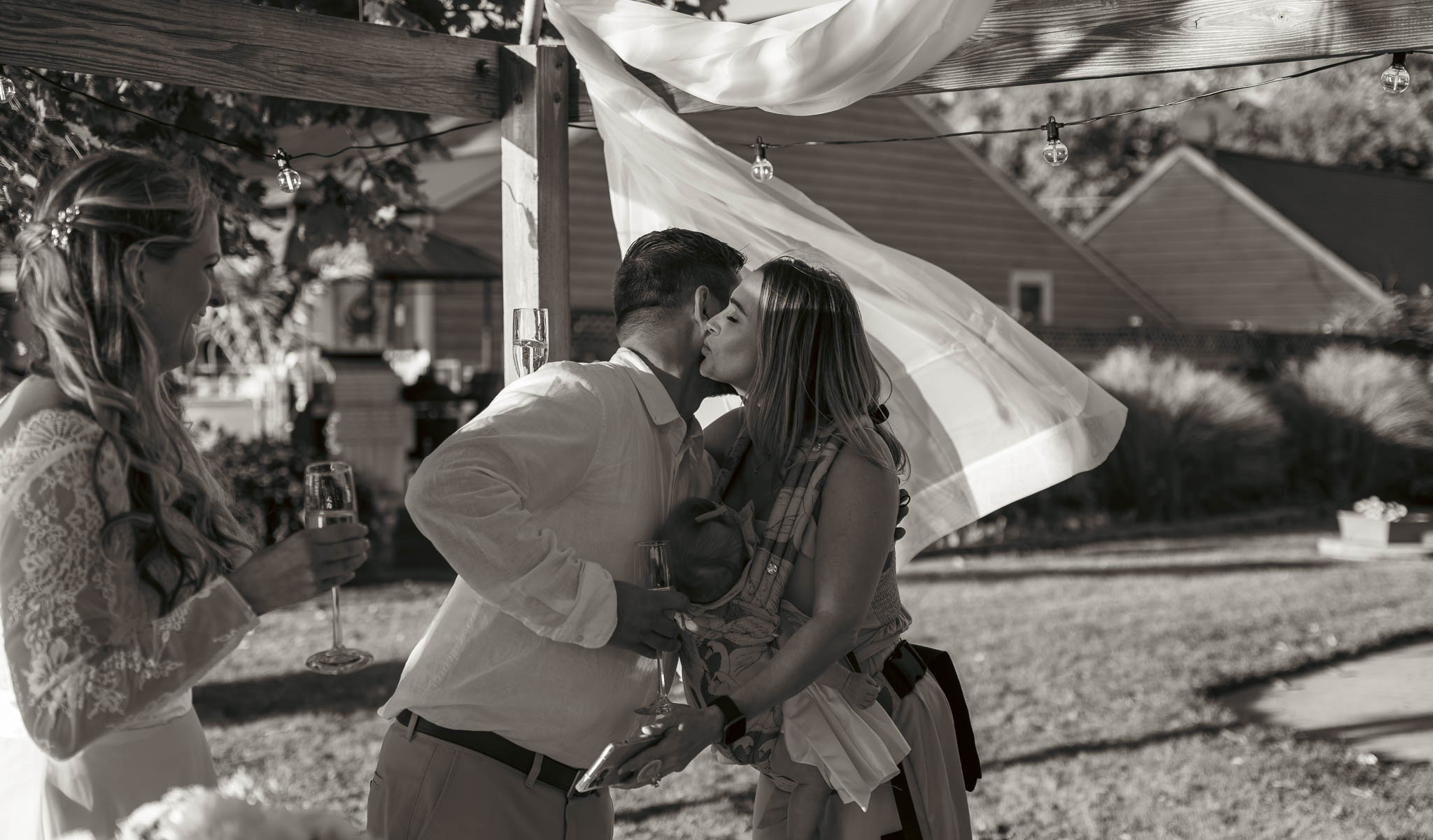 Friends catching up on the waterfront lawn — backyard wedding in Annapolis, Maryland