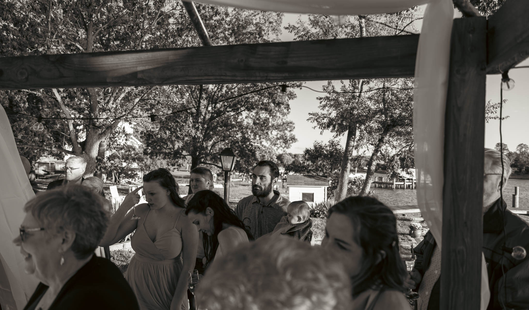 The party spreading out across the yard after the ceremony — backyard wedding in Annapolis, Maryland