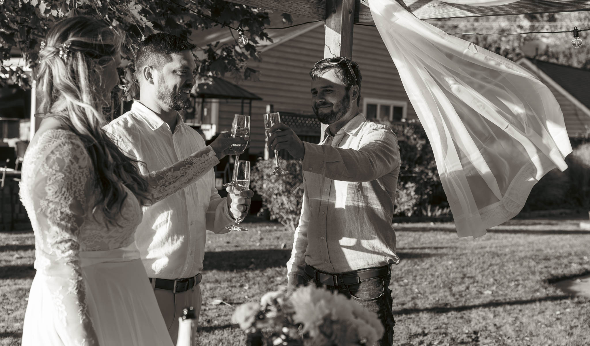 Friends catching up on the waterfront lawn — backyard wedding in Annapolis, Maryland