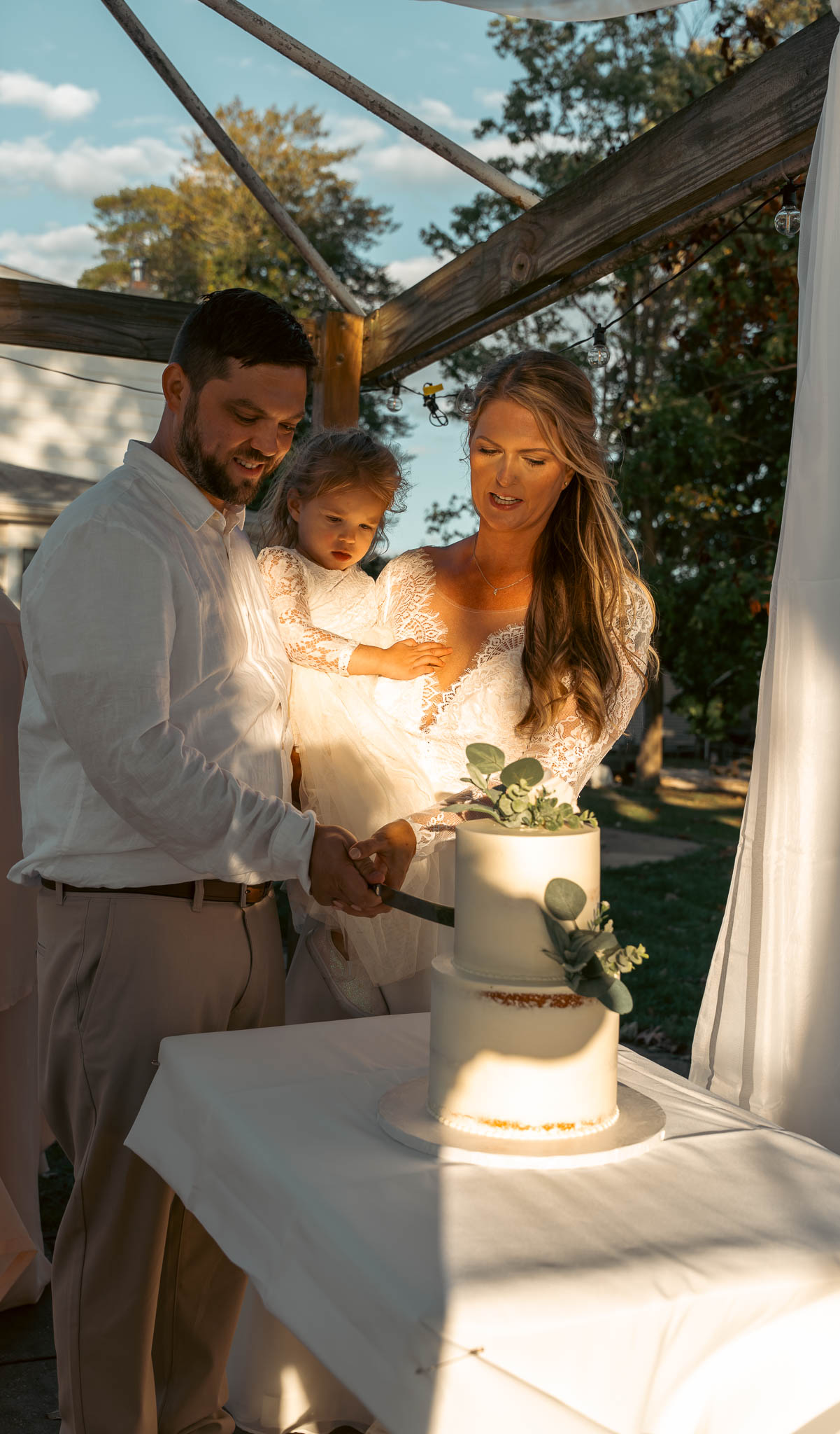 Cake cutting in the backyard at golden hour — backyard wedding in Annapolis, Maryland
