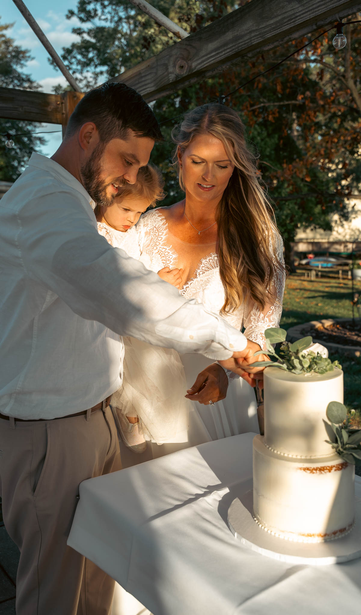 Cake cutting in the backyard at golden hour — backyard wedding in Annapolis, Maryland