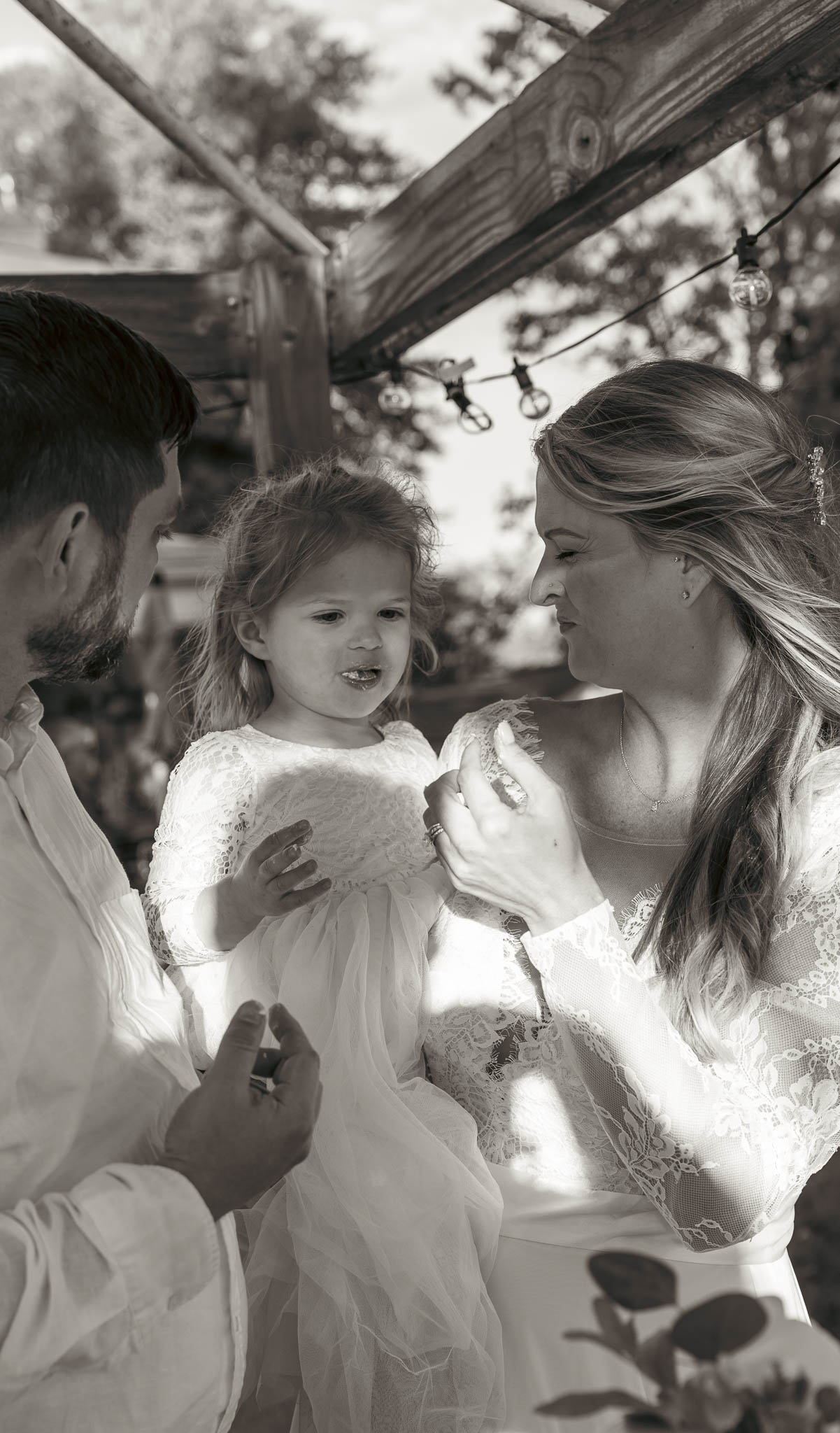 The couple cutting their wedding cake outdoors — backyard wedding in Annapolis, Maryland