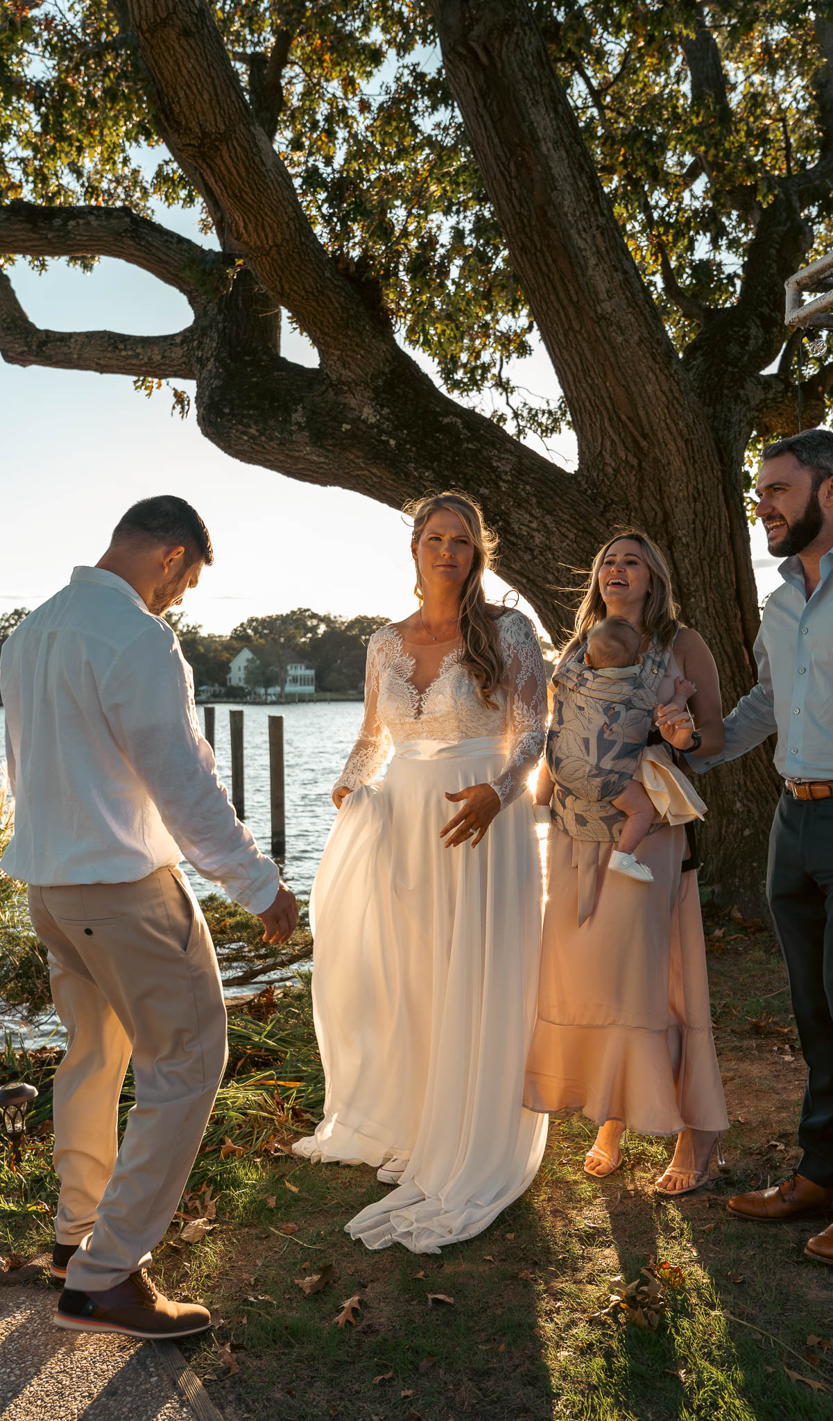 Guests in the backyard by the water after the ceremony — backyard wedding in Annapolis, Maryland