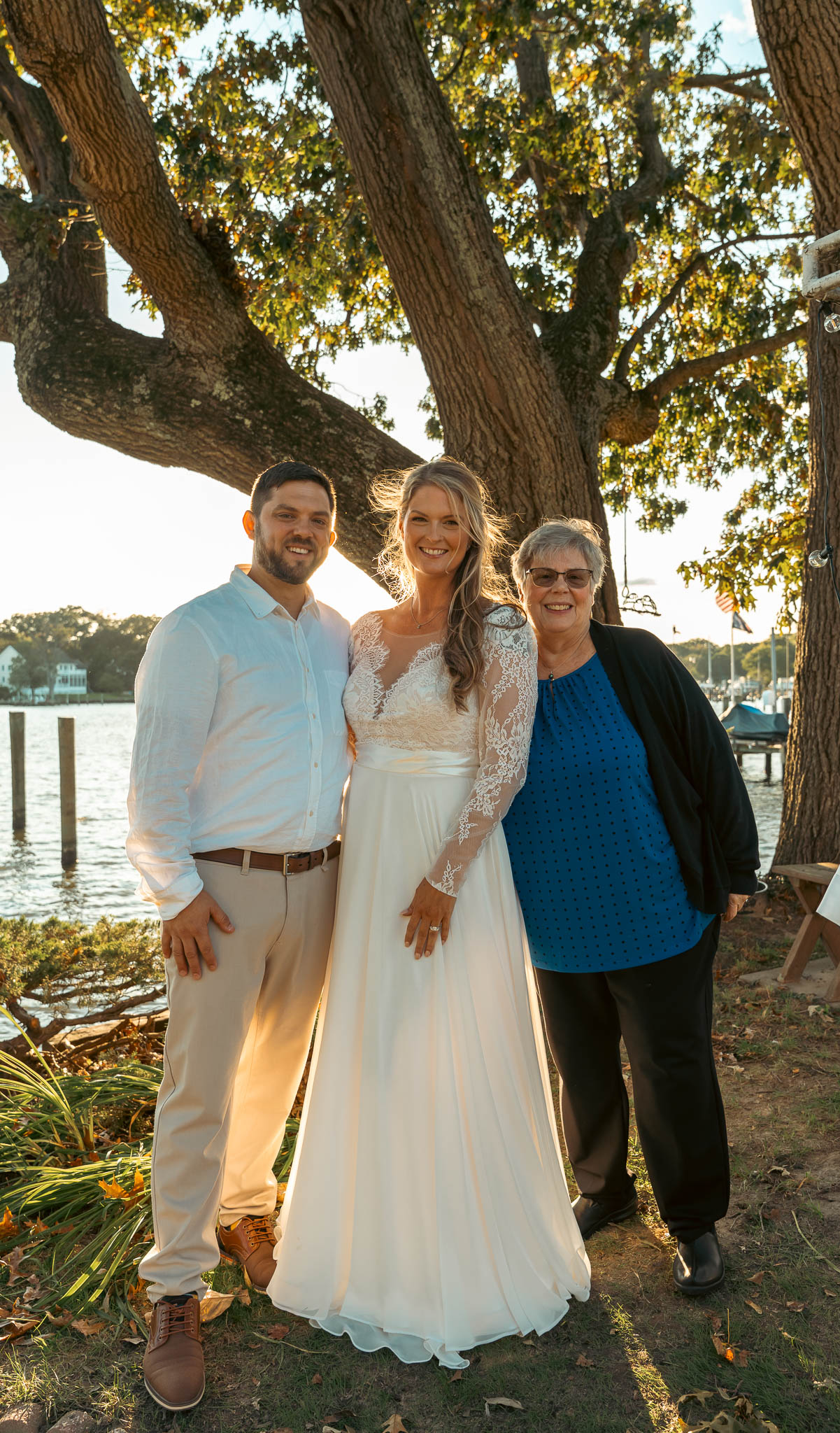 Guests in the backyard by the water after the ceremony — backyard wedding in Annapolis, Maryland