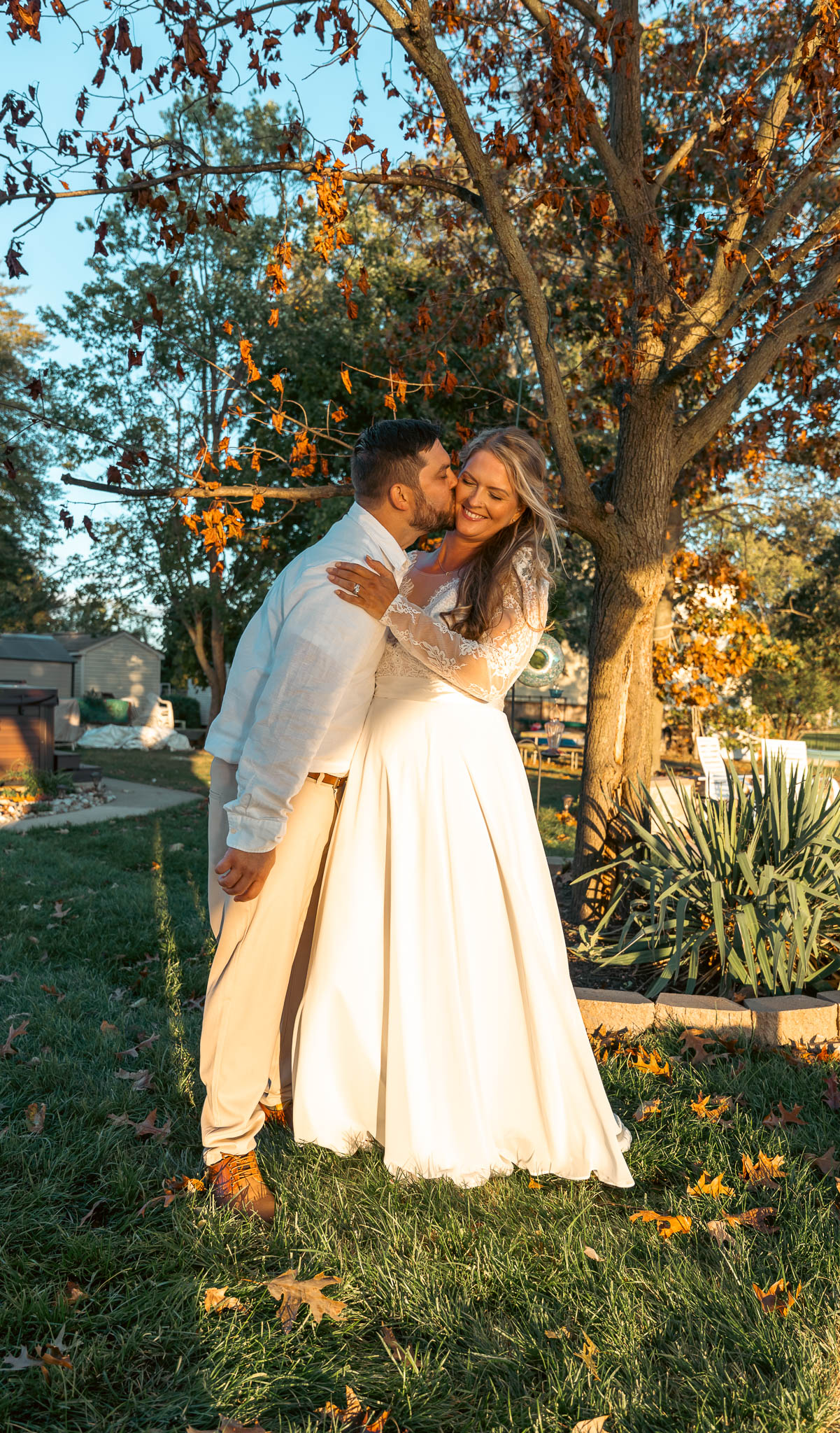 Warm evening portrait of the newlyweds by the creek — backyard wedding in Annapolis, Maryland