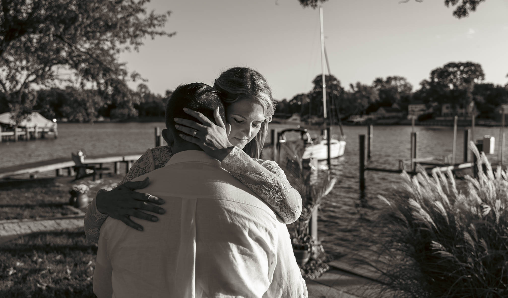 Warm evening portrait of the newlyweds by the creek — backyard wedding in Annapolis, Maryland