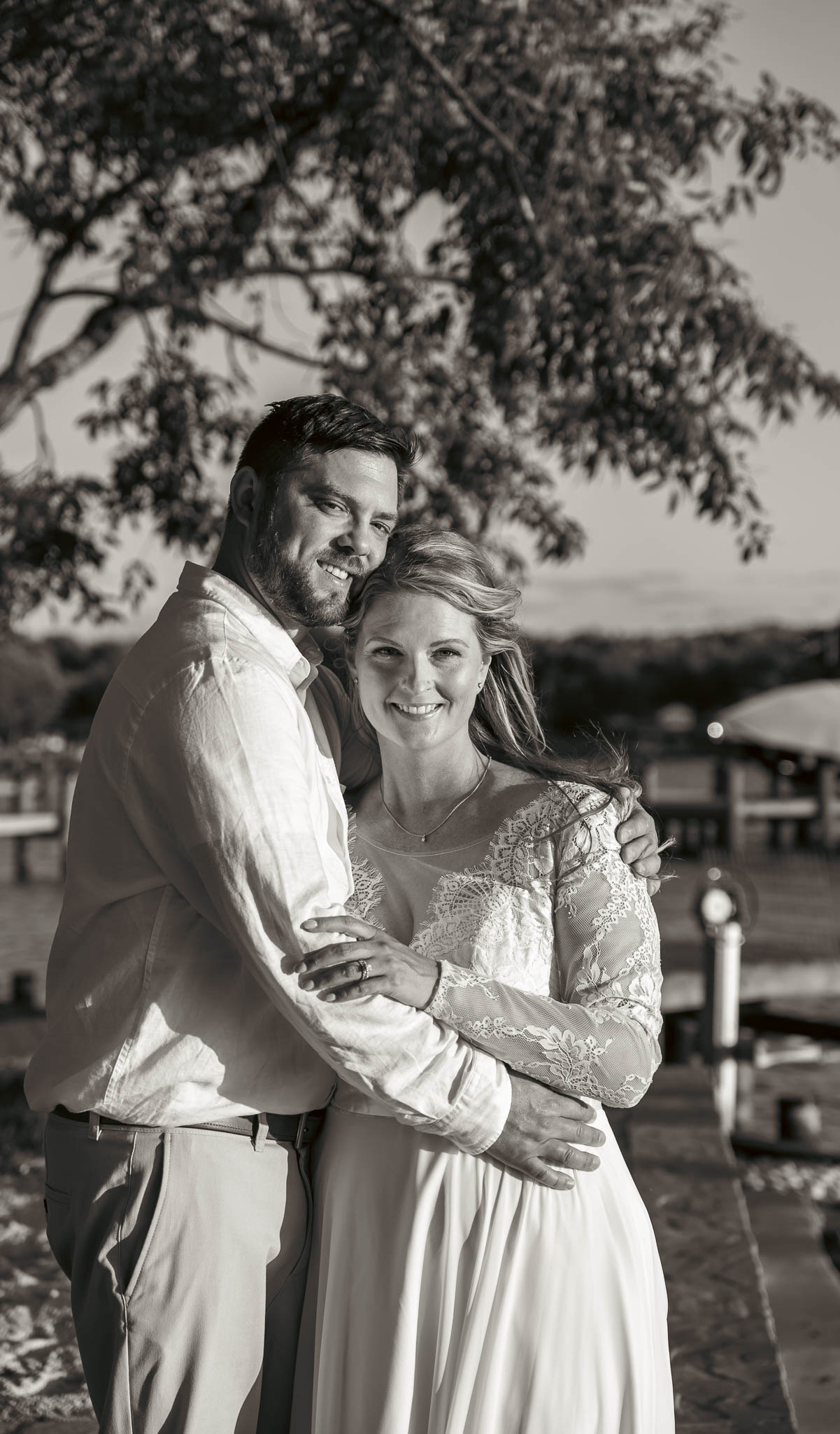 Warm evening portrait of the newlyweds by the creek — backyard wedding in Annapolis, Maryland