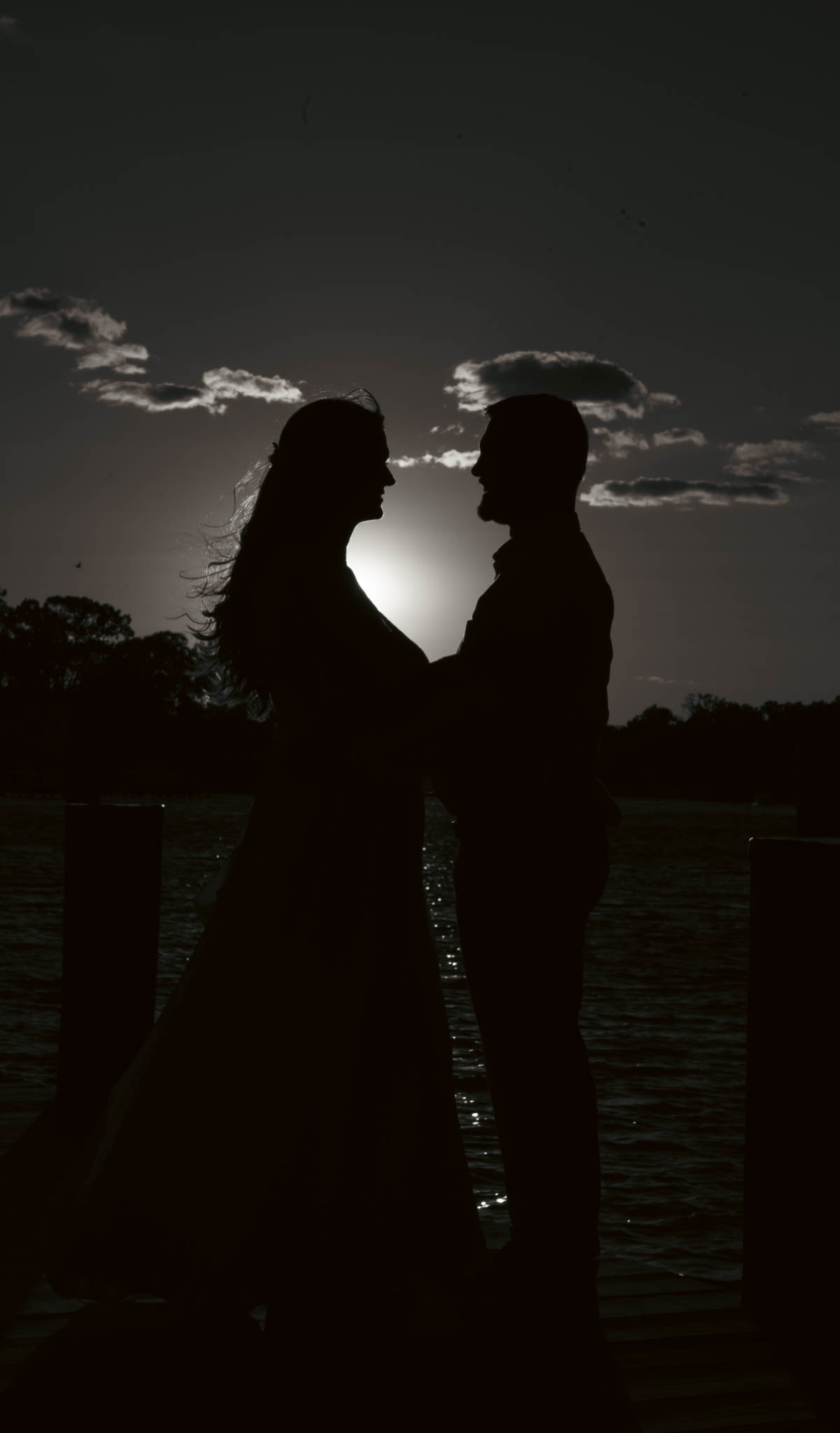 The couple on the dock as the sun goes down over the water — backyard wedding in Annapolis, Maryland