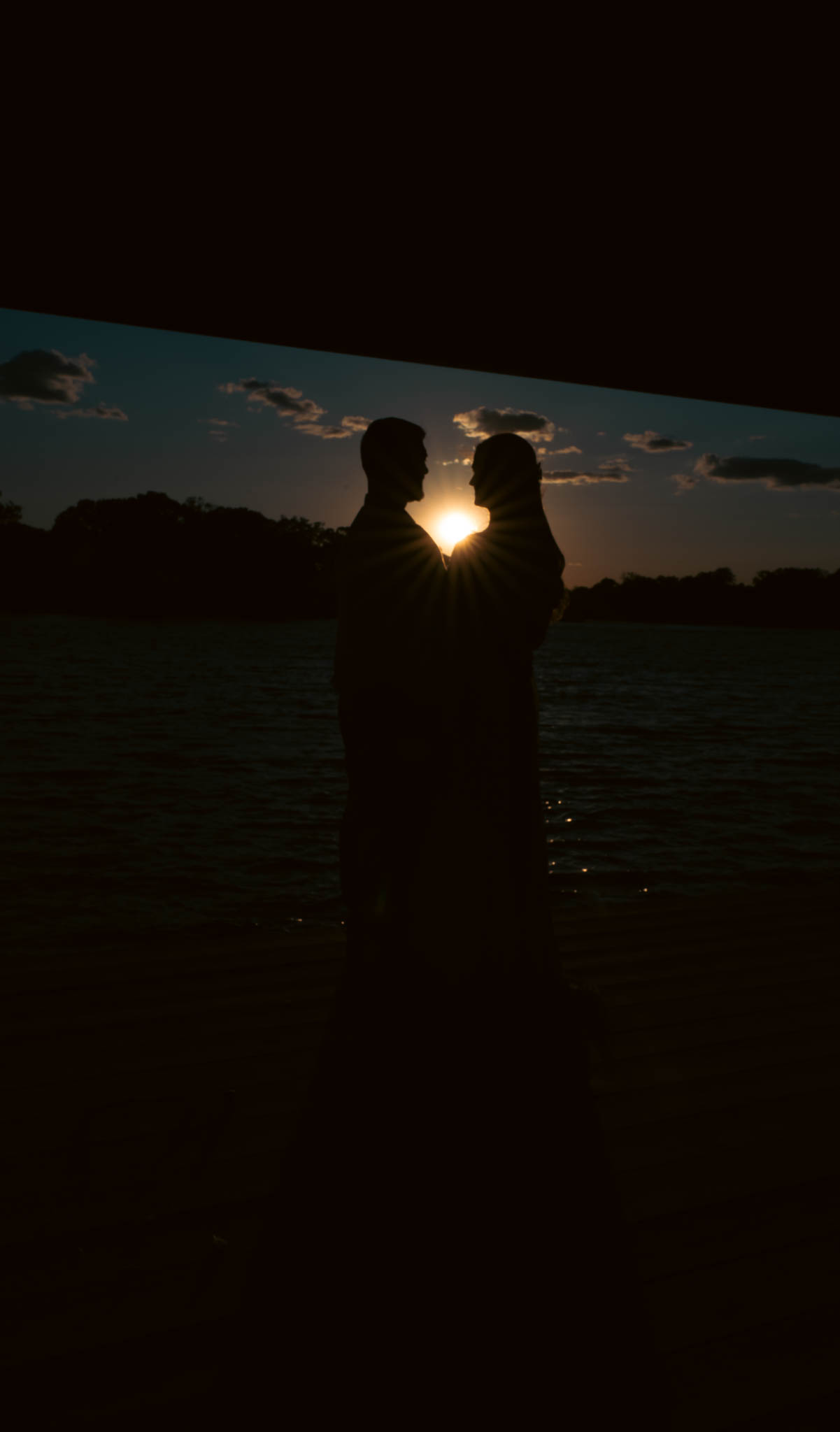 The couple on the dock as the sun goes down over the water — backyard wedding in Annapolis, Maryland