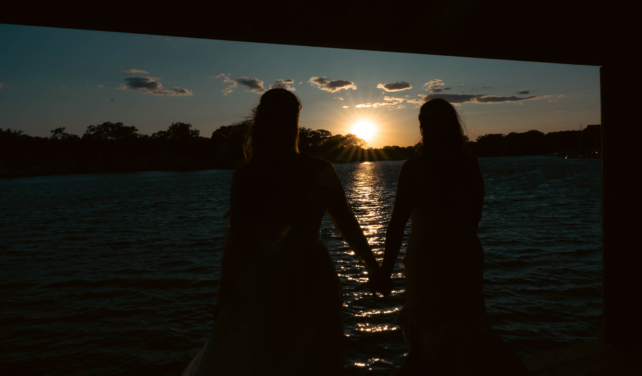 The couple on the dock as the sun goes down over the water — backyard wedding in Annapolis, Maryland