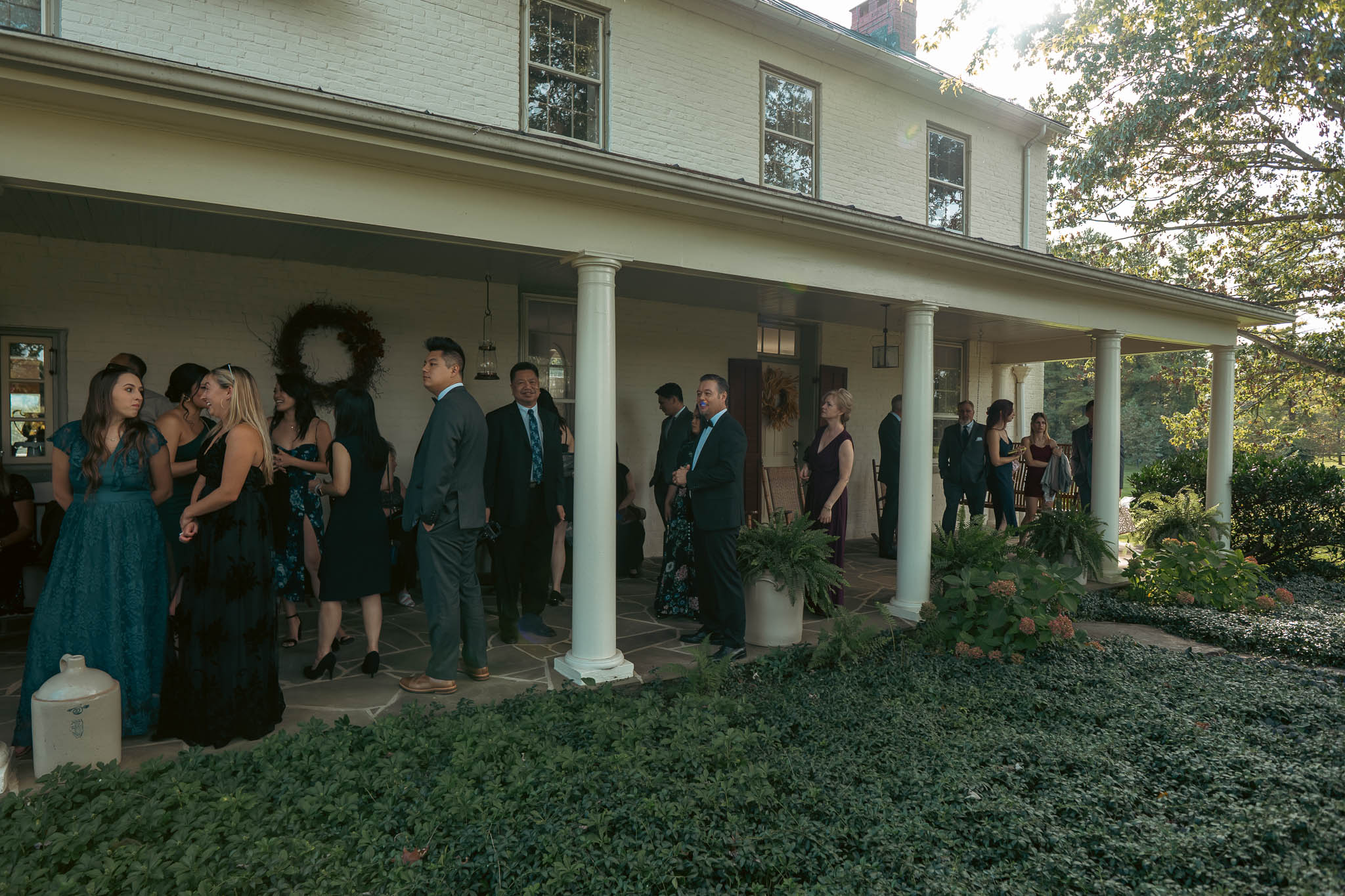 Guests gathering under the oaks before the ceremony — Sylvanside Farm wedding in Purcellville, Virginia