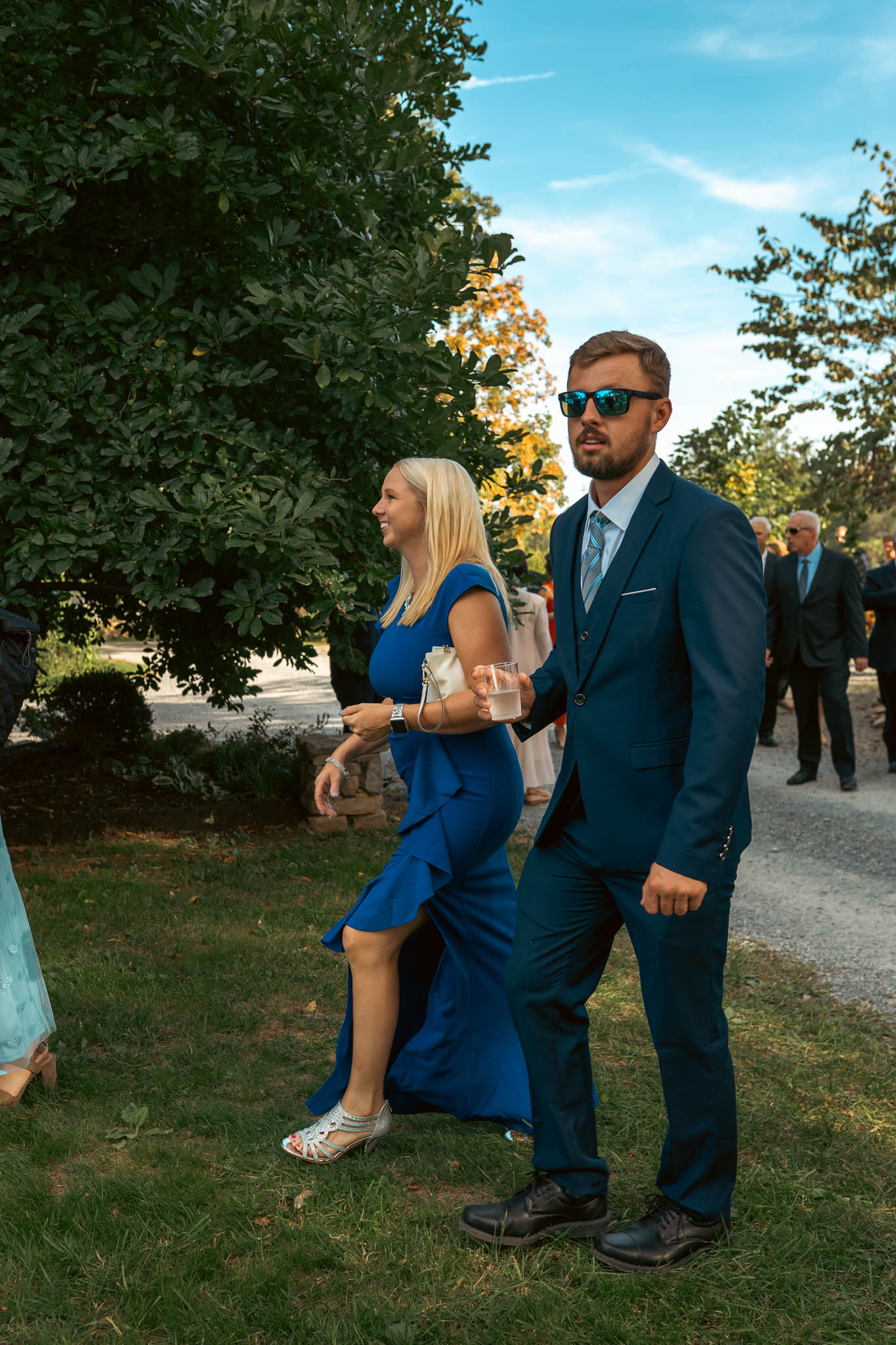 Guests crossing the farm lane on an October afternoon — Sylvanside Farm wedding in Purcellville, Virginia
