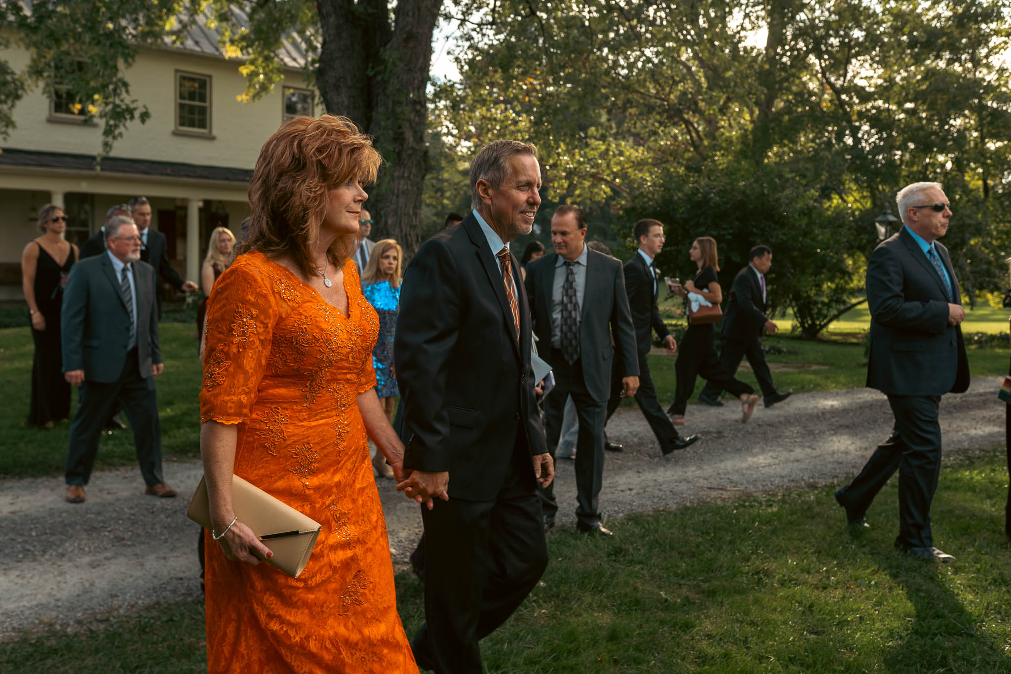 Guests crossing the farm lane on an October afternoon — Sylvanside Farm wedding in Purcellville, Virginia