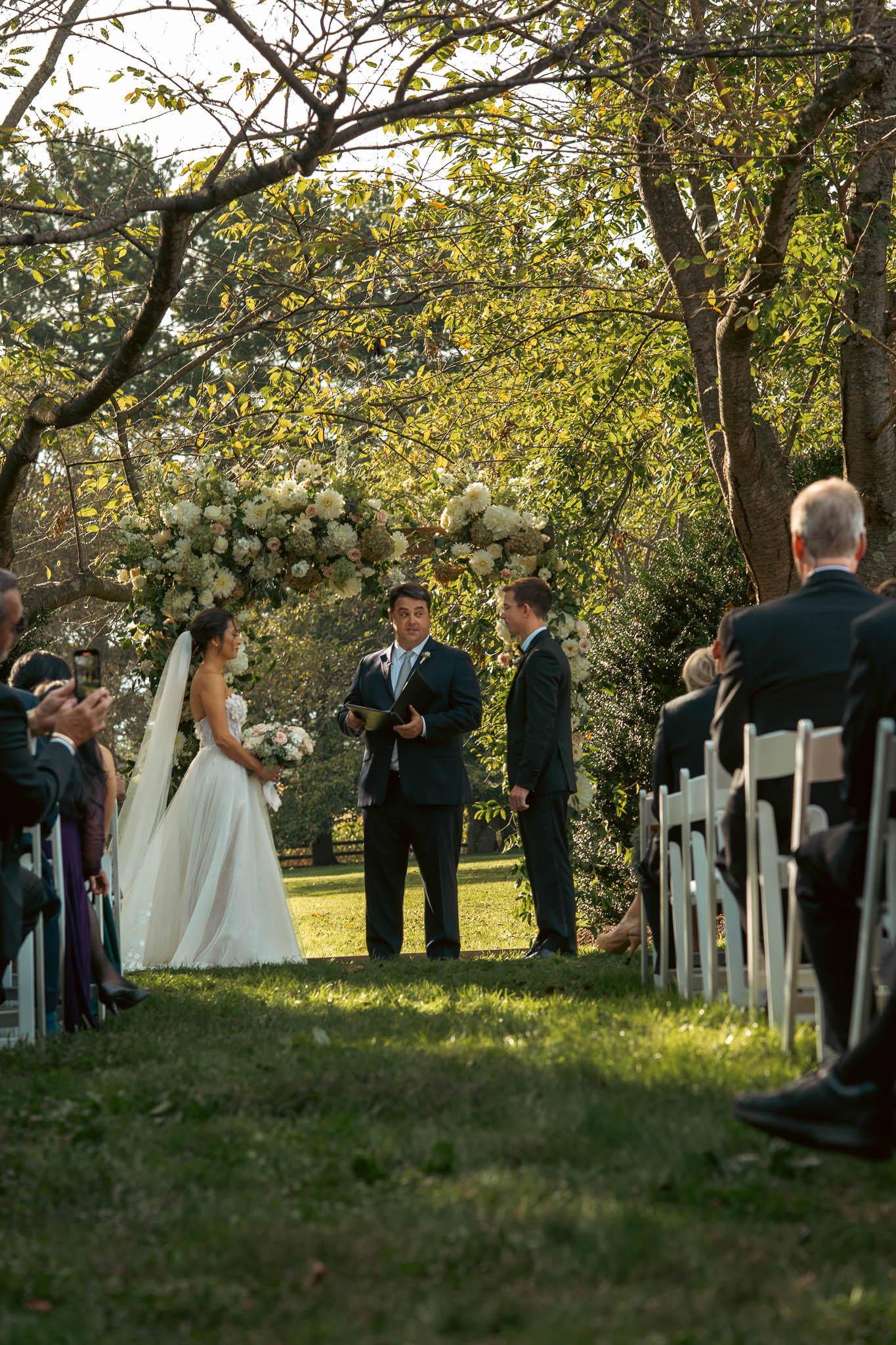Lawn ceremony under a floral arch — Sylvanside Farm wedding in Purcellville, Virginia