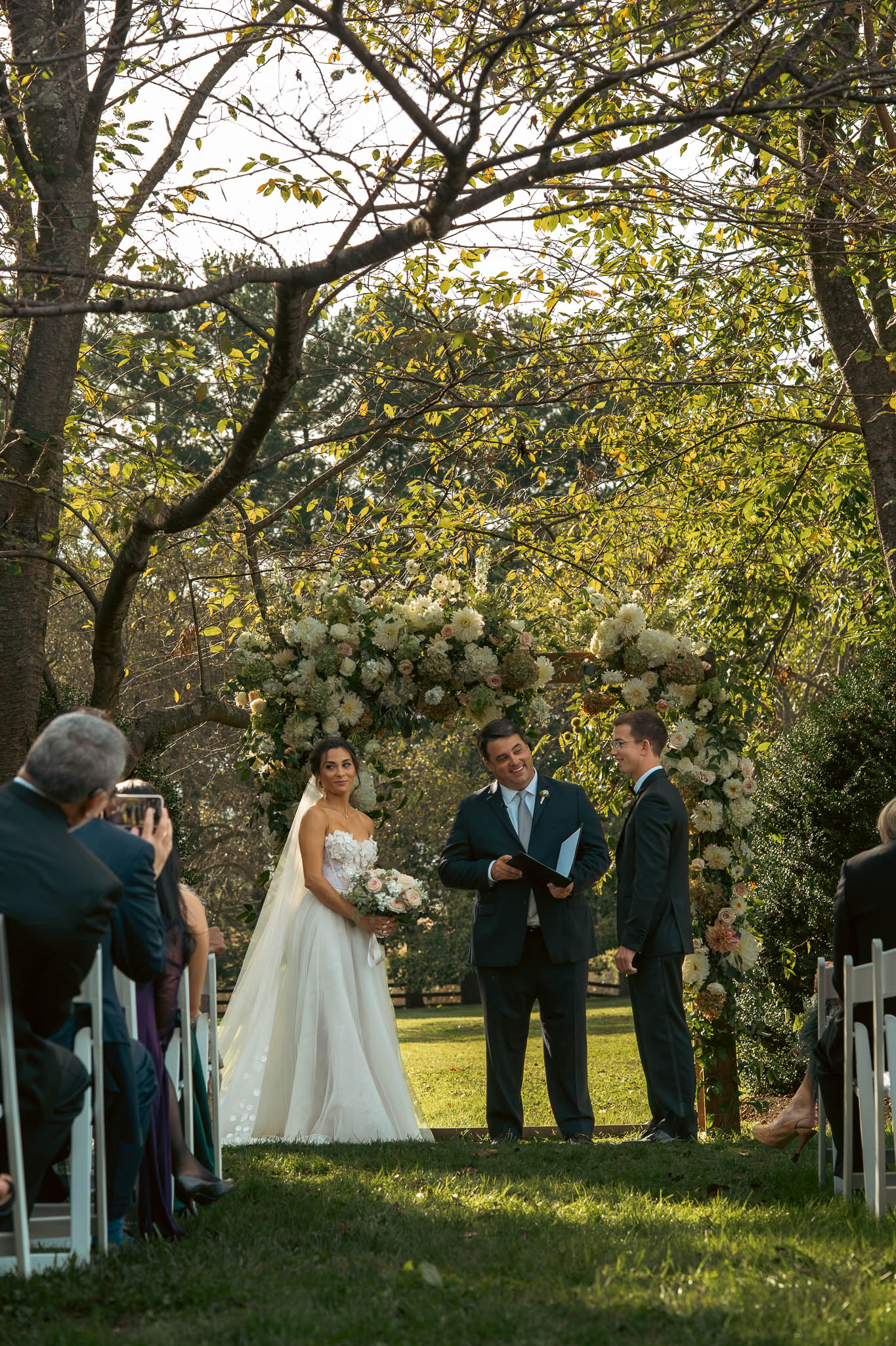 The ceremony under the oaks on an October afternoon — Sylvanside Farm wedding in Purcellville, Virginia