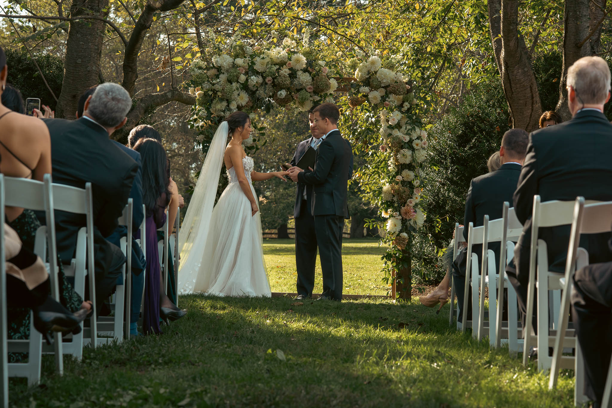 Lawn ceremony under a floral arch — Sylvanside Farm wedding in Purcellville, Virginia