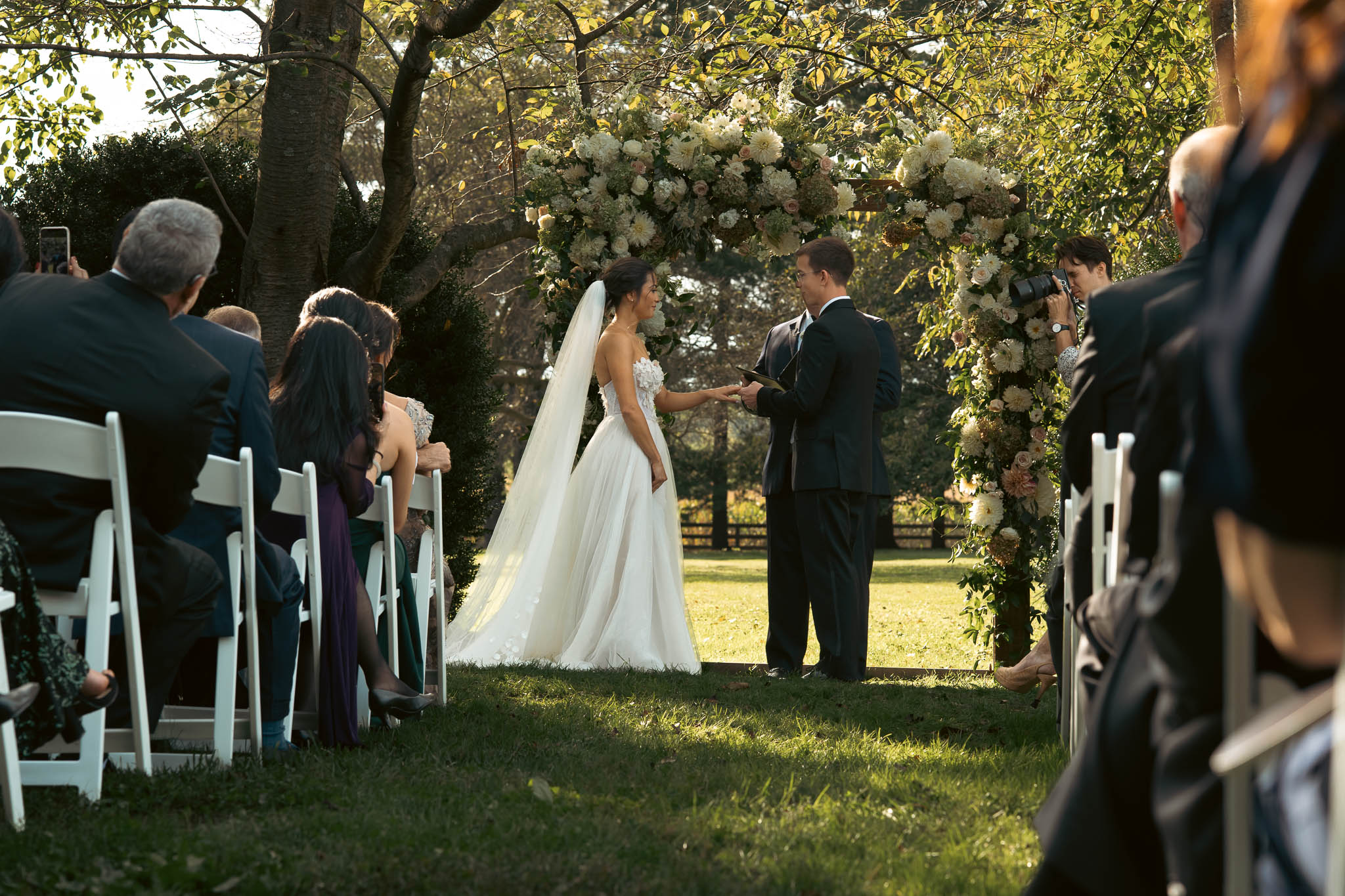 The ceremony under the oaks on an October afternoon — Sylvanside Farm wedding in Purcellville, Virginia