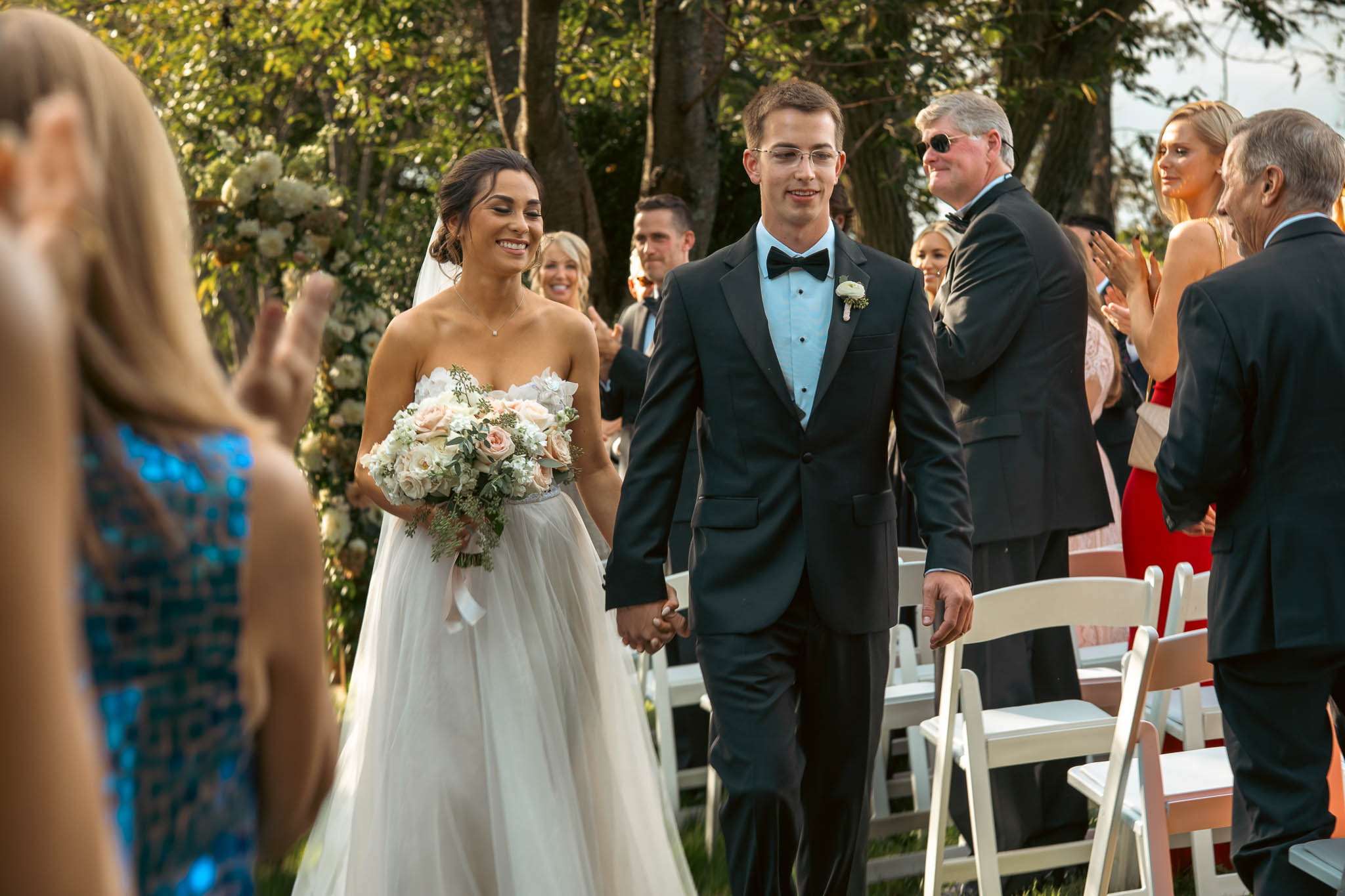 Lawn ceremony under a floral arch — Sylvanside Farm wedding in Purcellville, Virginia