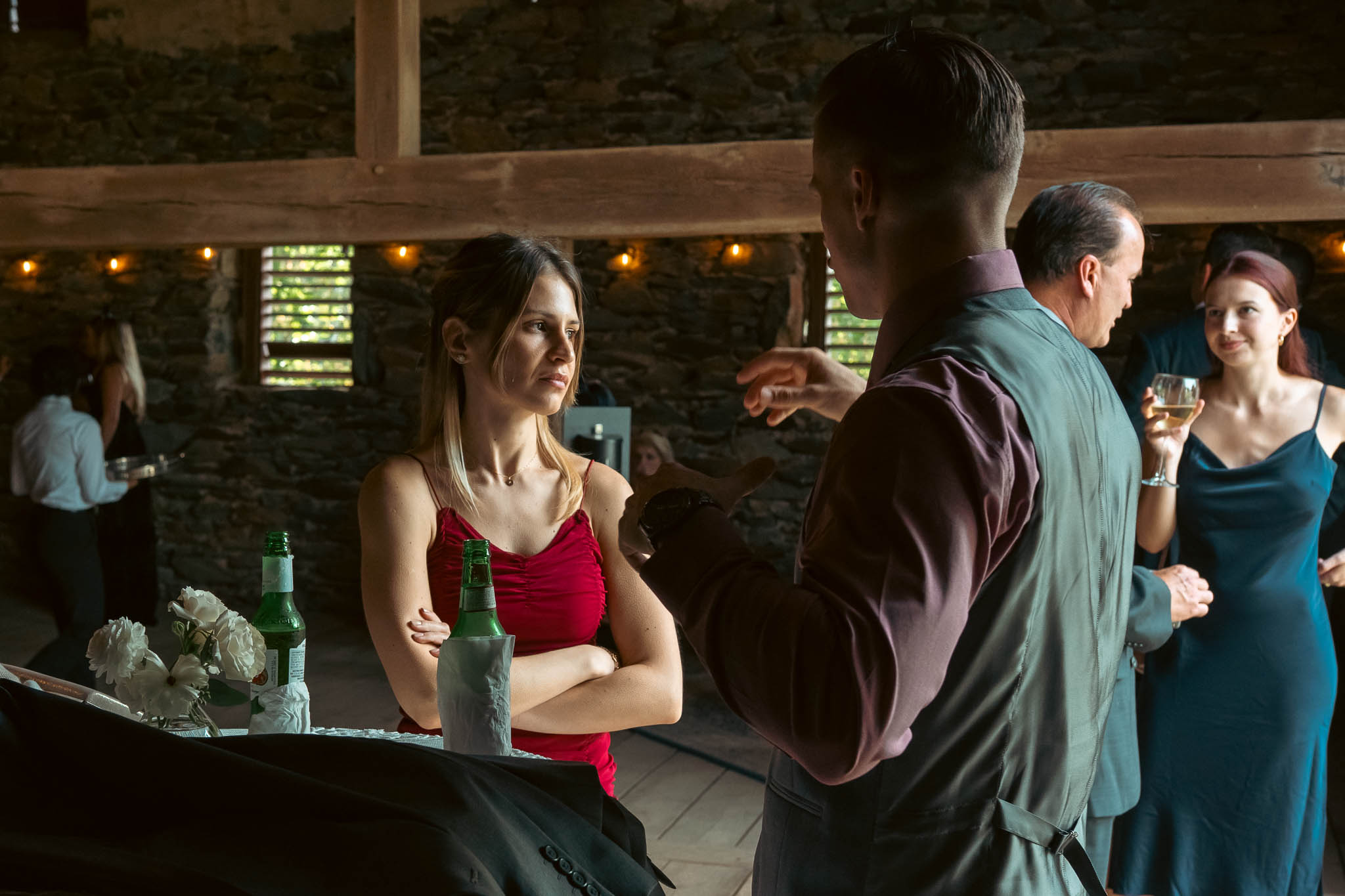 Cocktail hour beside the historic stone bank barn — Sylvanside Farm wedding in Purcellville, Virginia