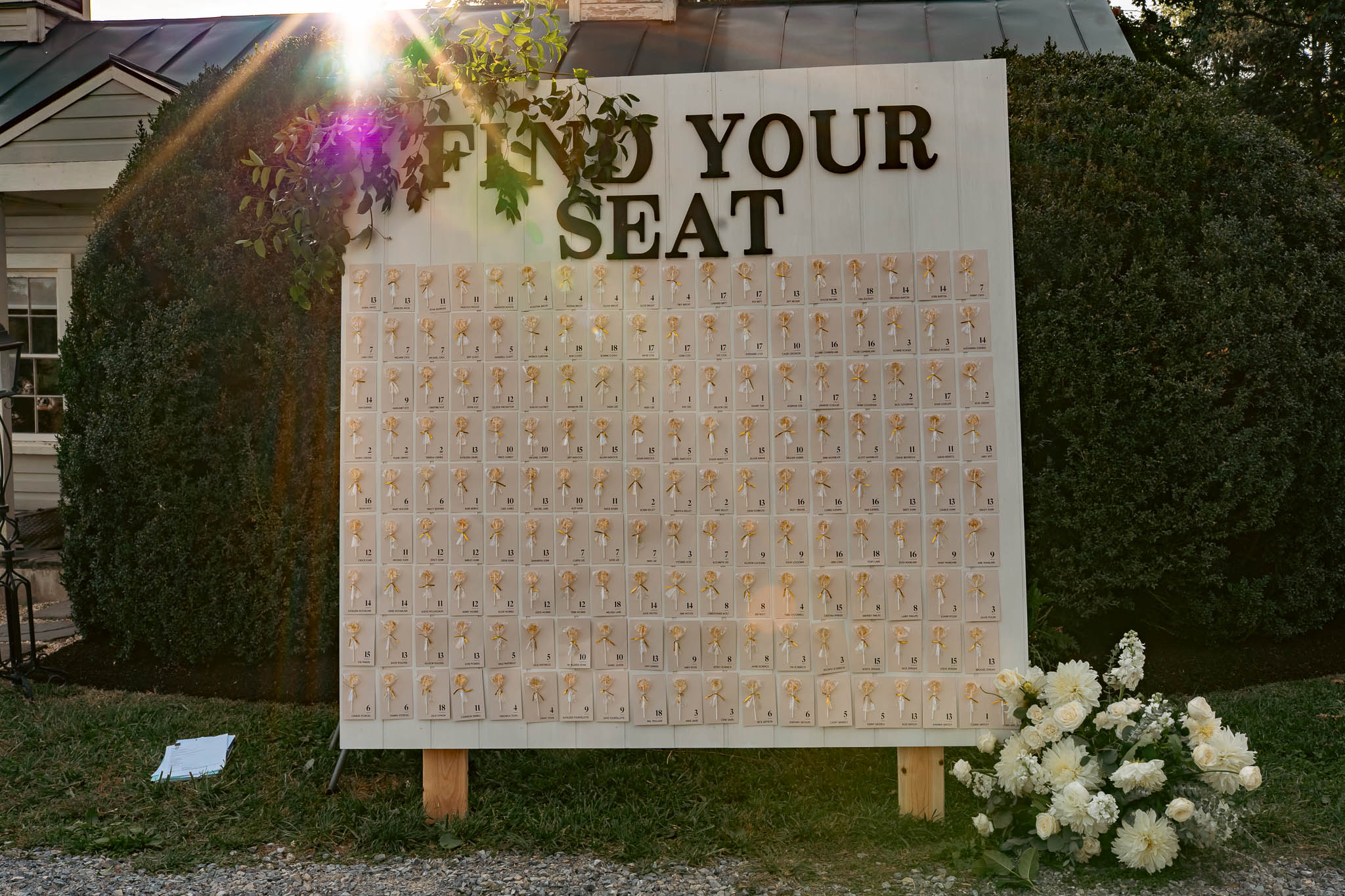 Find-your-seat escort card display on the farm lawn — Sylvanside Farm wedding in Purcellville, Virginia