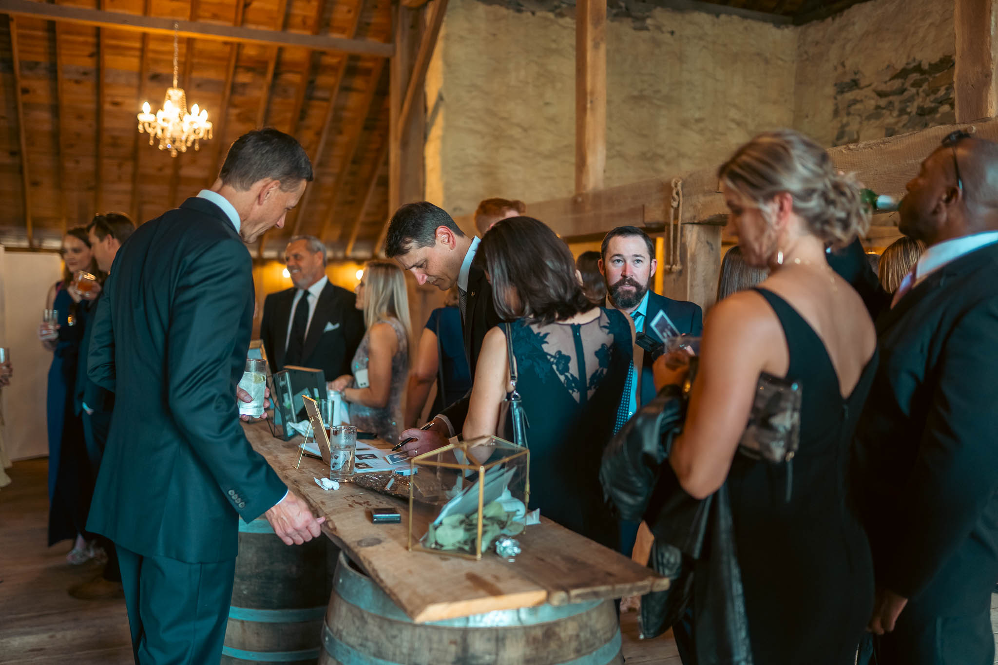 Cocktail hour beside the historic stone bank barn — Sylvanside Farm wedding in Purcellville, Virginia