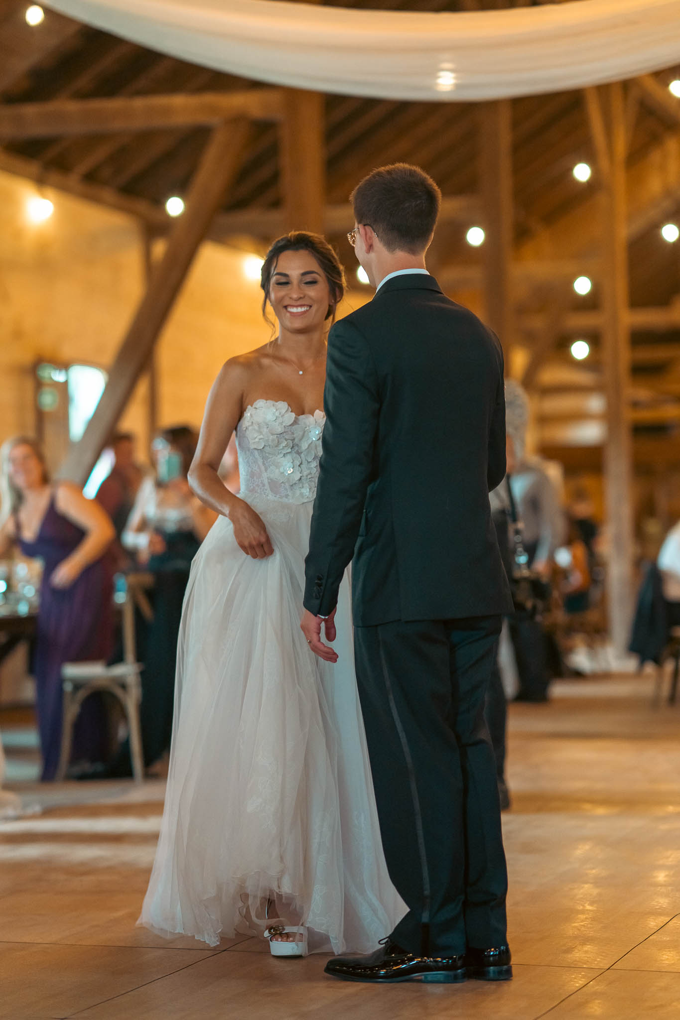 Bride and groom's first dance under the barn string lights — Sylvanside Farm wedding in Purcellville, Virginia