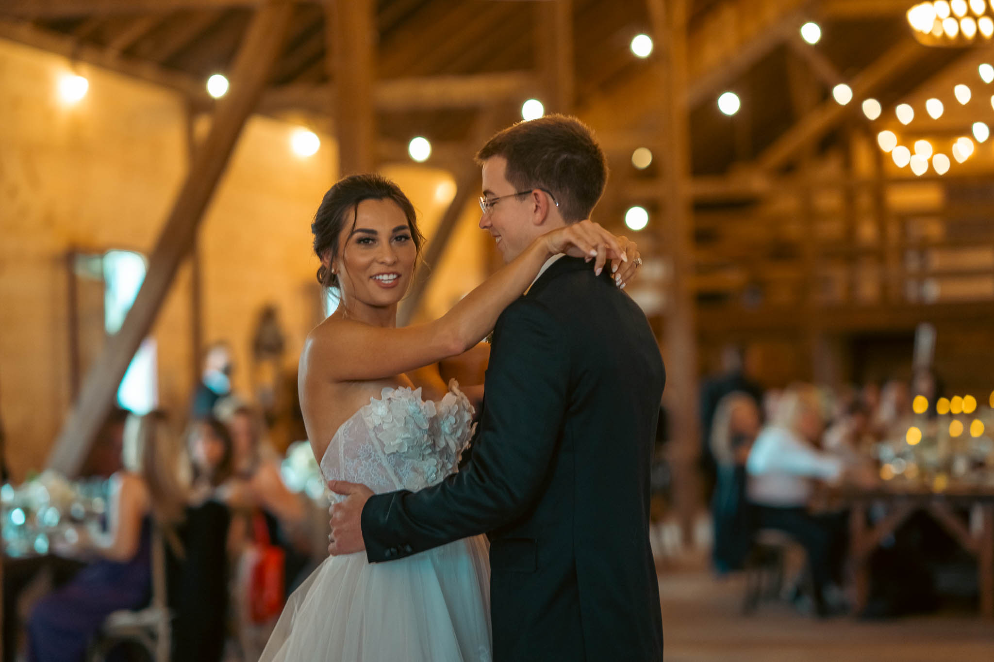 Bride and groom's first dance under the barn string lights — Sylvanside Farm wedding in Purcellville, Virginia