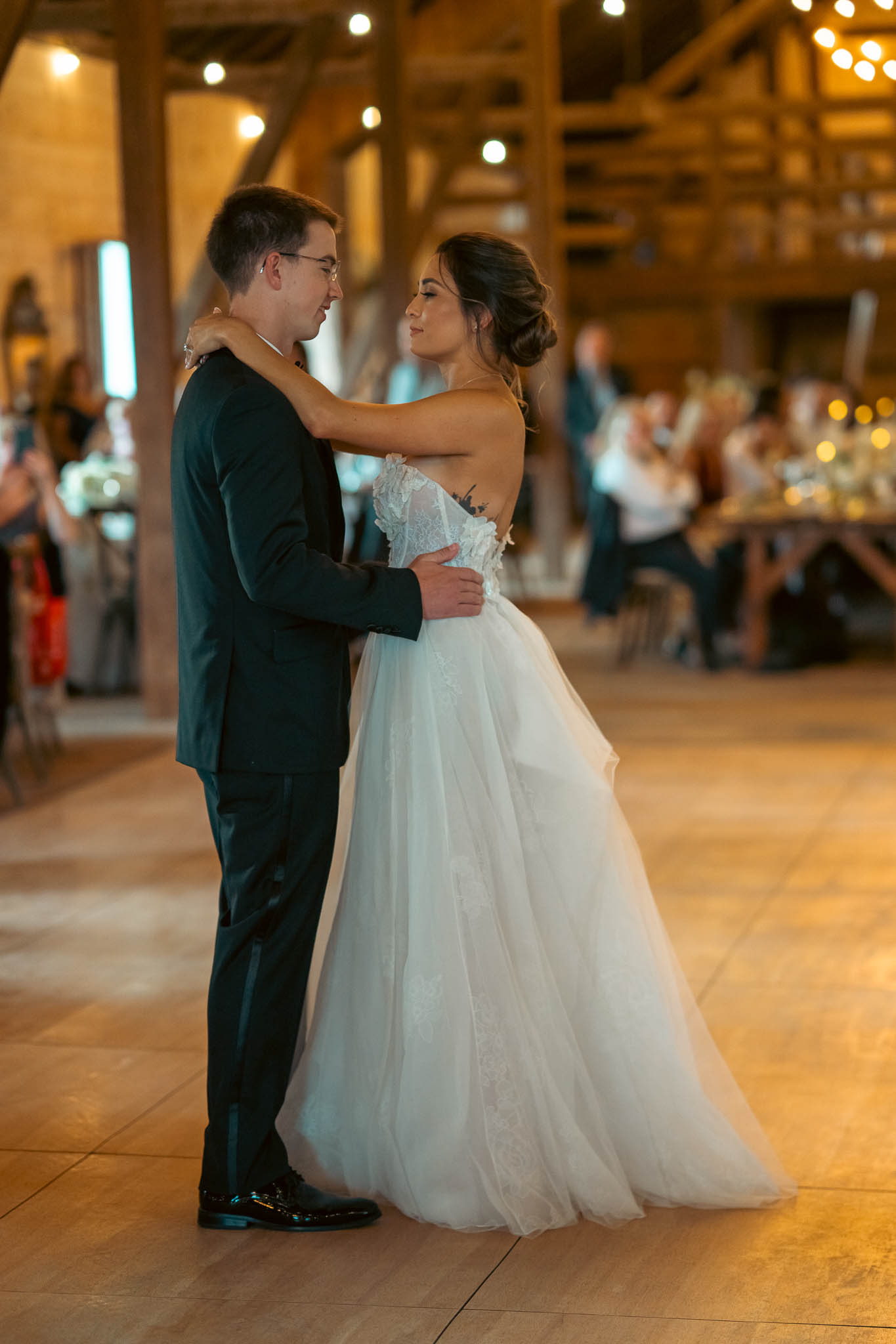 Black and white first dance photograph in the barn — Sylvanside Farm wedding in Purcellville, Virginia