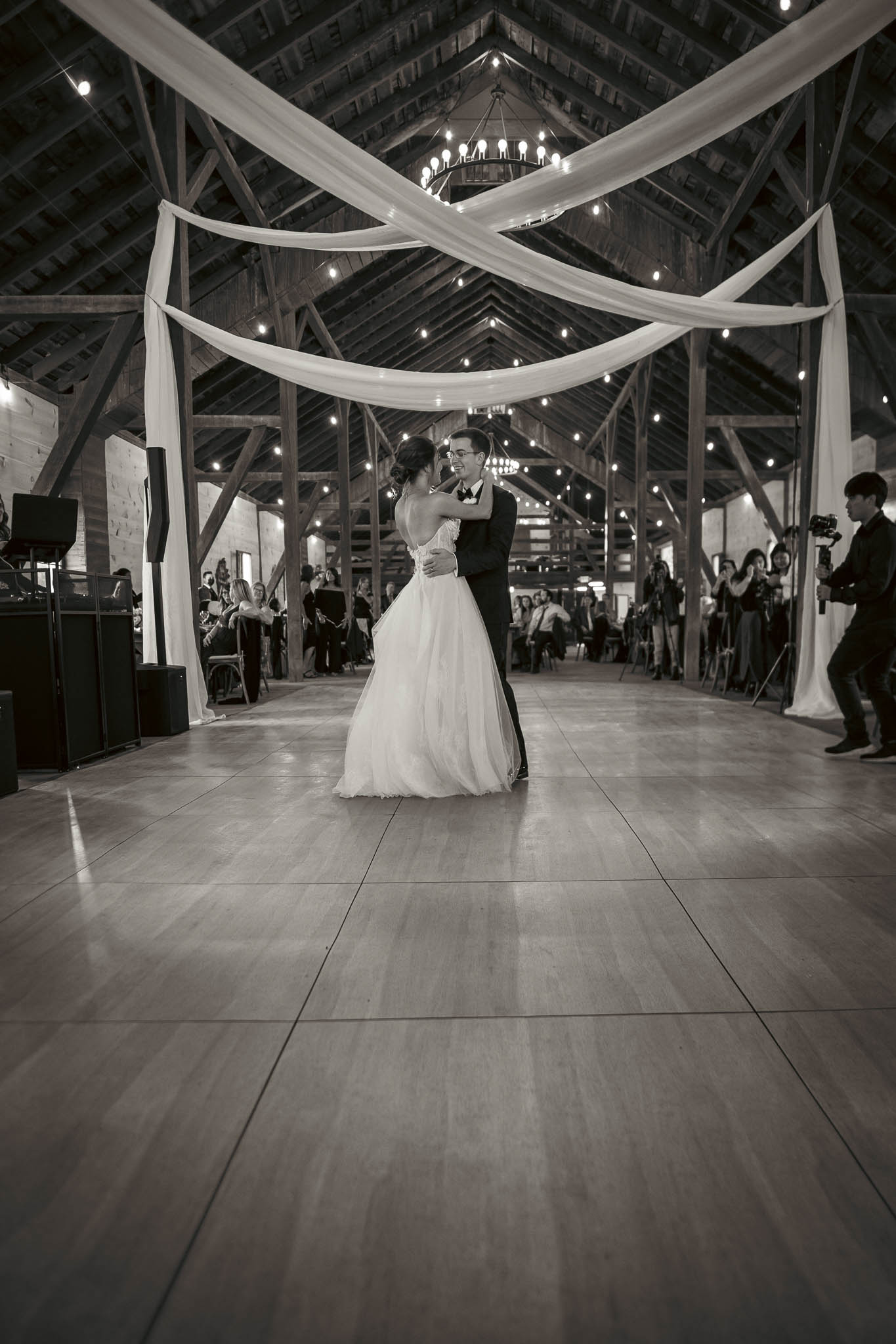 Bride and groom's first dance under the barn string lights — Sylvanside Farm wedding in Purcellville, Virginia