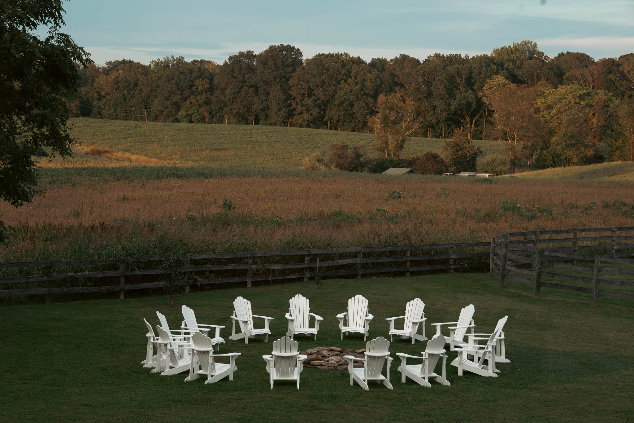 Fire pit and adirondack chairs overlooking the fields at dusk — Sylvanside Farm wedding in Purcellville, Virginia